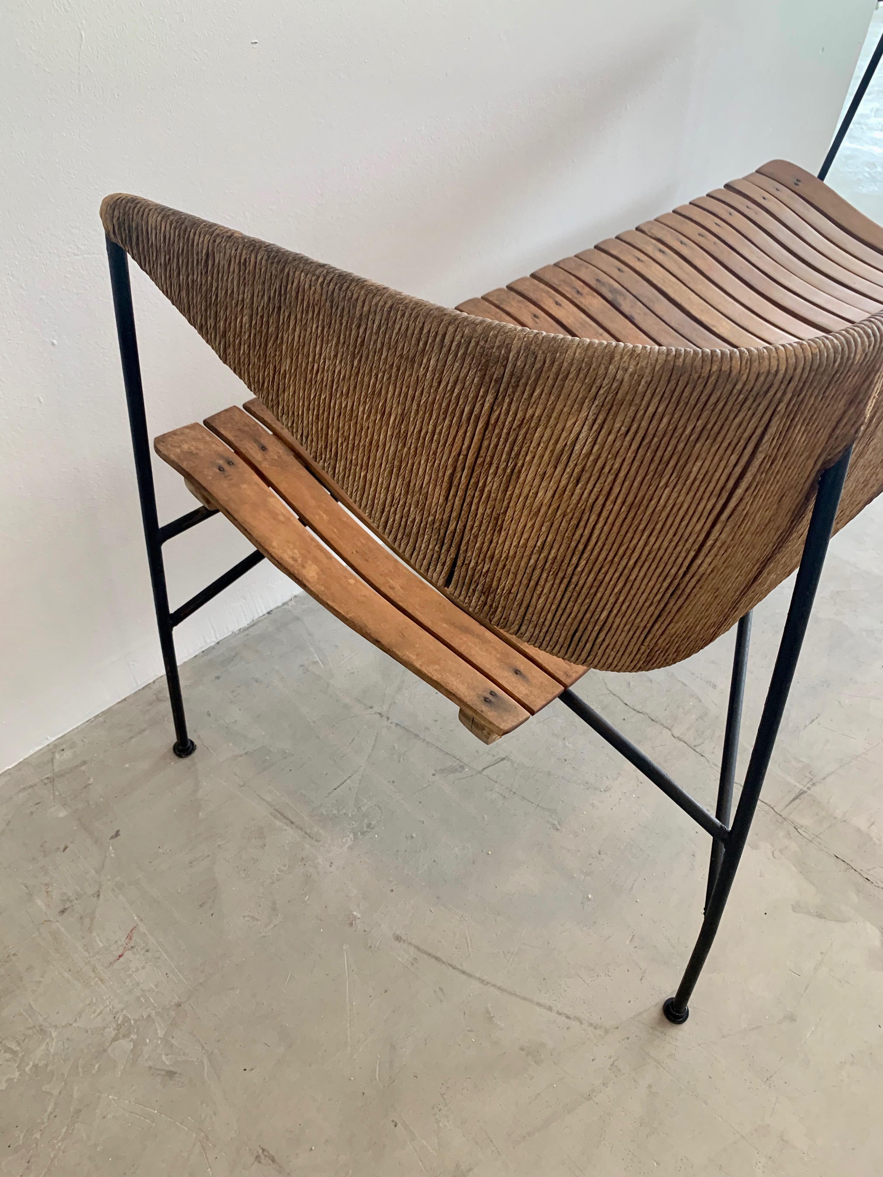 Rare sculptural bench/settee by Arthur Umanoff. Signature rush back floats above the slatted wood seat, and iron frame. Great lines and scale. Good vintage condition.

  