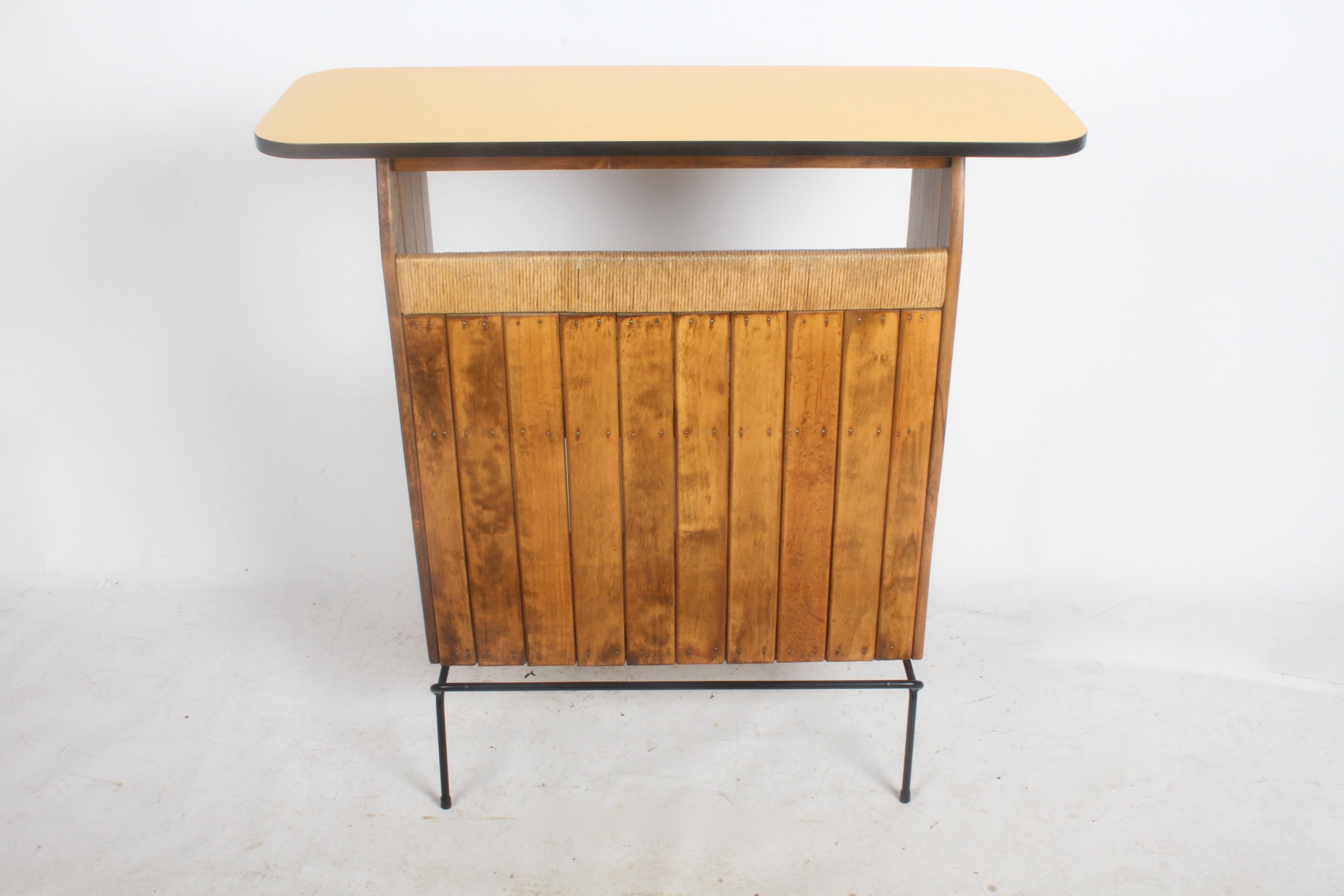 Midcentury Arthur Umanoff bar for Raymor. Wrought iron base, oak slats, rush and Formica top. Overall nice original condition, oak restored, wrought iron base repainted, top in very nice condition, no issues. Top surface is 15