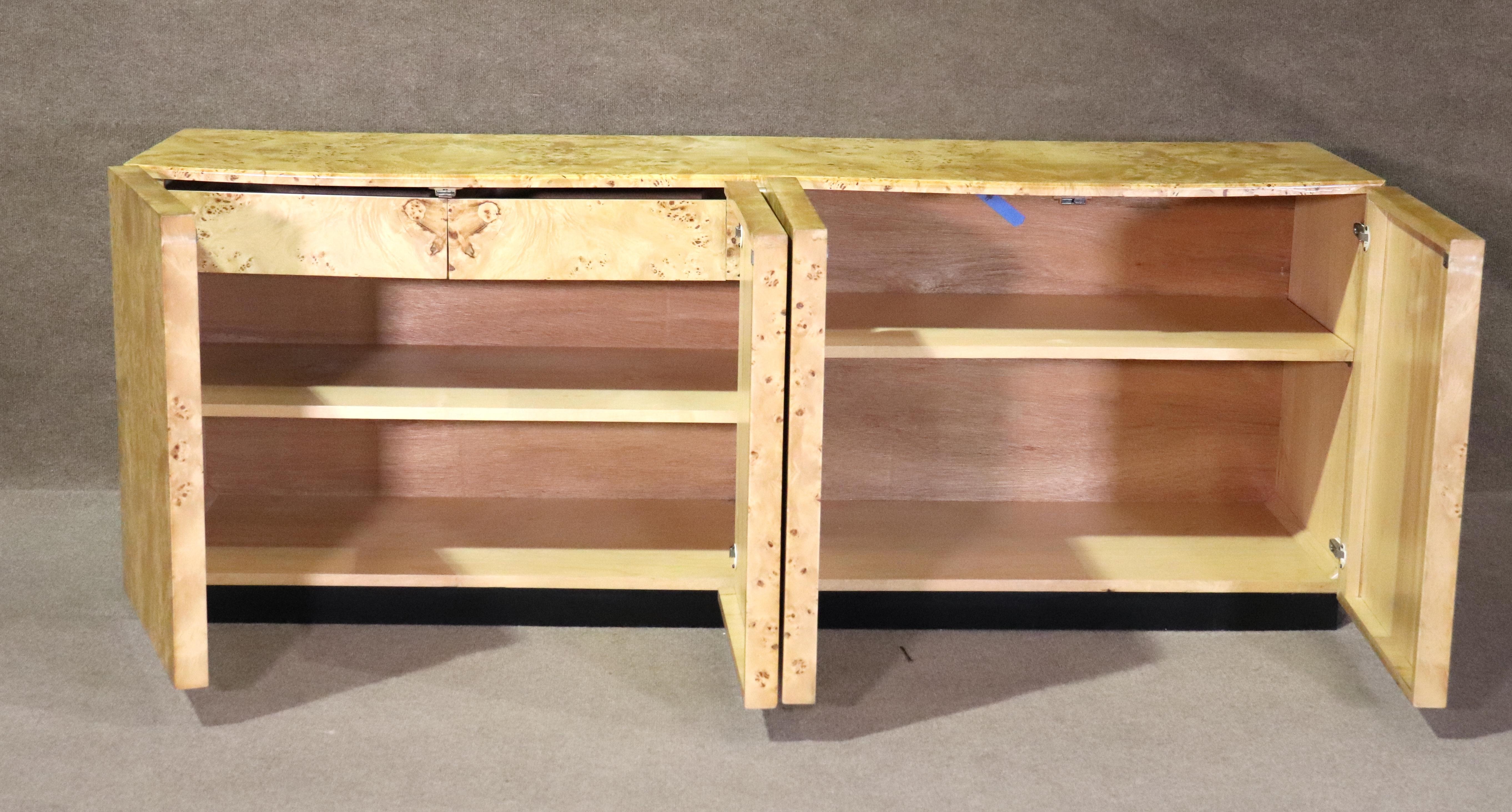 Many modern cabinets try to emulate the style, but the original is always better! Arthur Umanoff designed this simple and handsome credenza for Dilligham in the 1970s, and it looks more modern than ever. The burl wood makes for a striking and eye