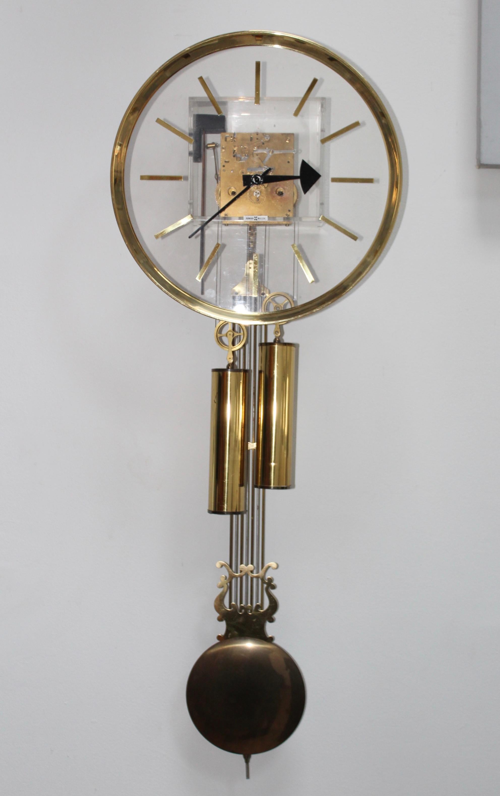 1970s Lucite and brass eight day clock, designed by Arthur Umanoff for Howard Miller.