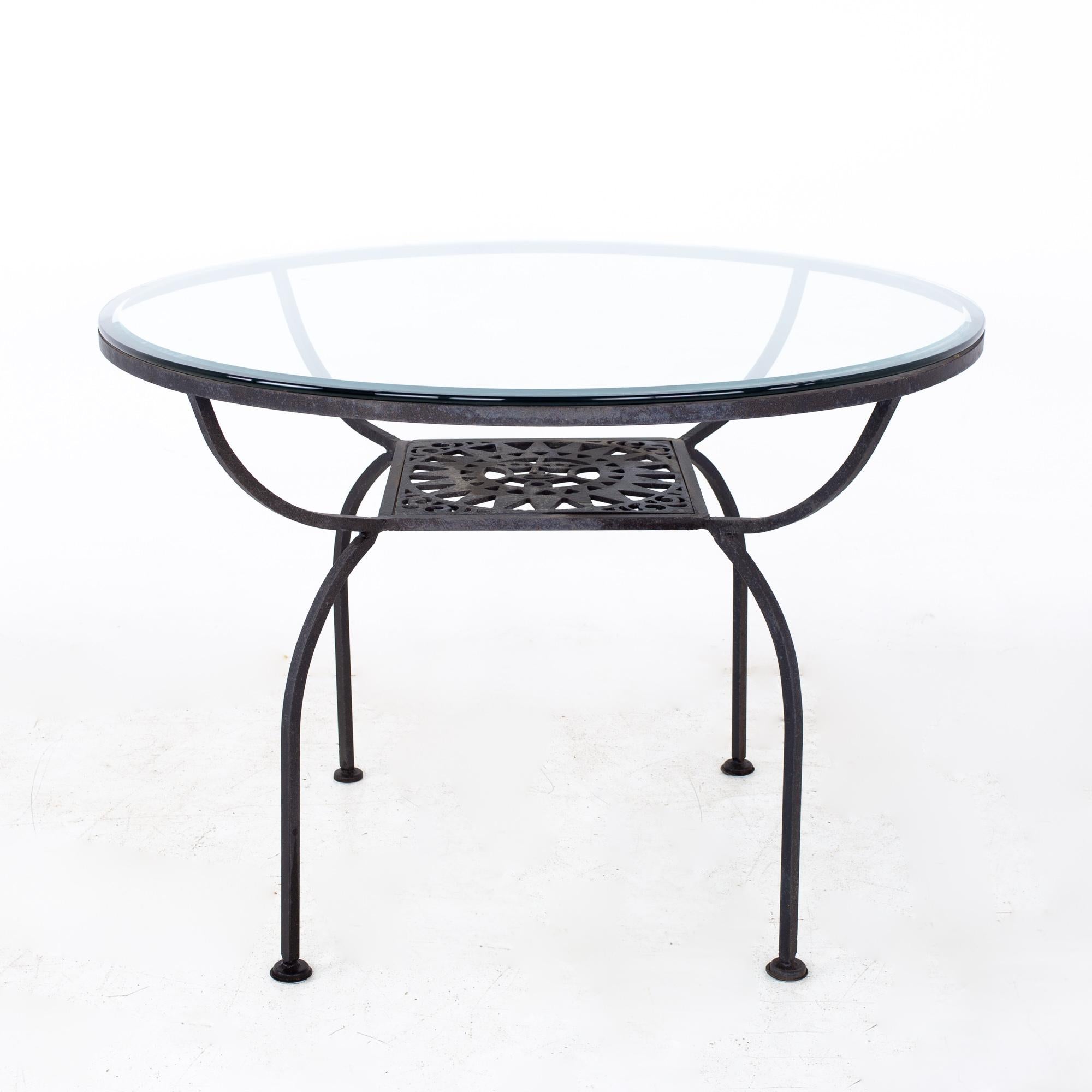 Arthur Umanoff for Shaver Howard Mayan Mid Century Iron and Glass Round Dining Table

The table measures: 42 wide x 42 deep x 29.75 high, with a chair clearance of 28.5 inches

All pieces of furniture can be had in what we call restored vintage