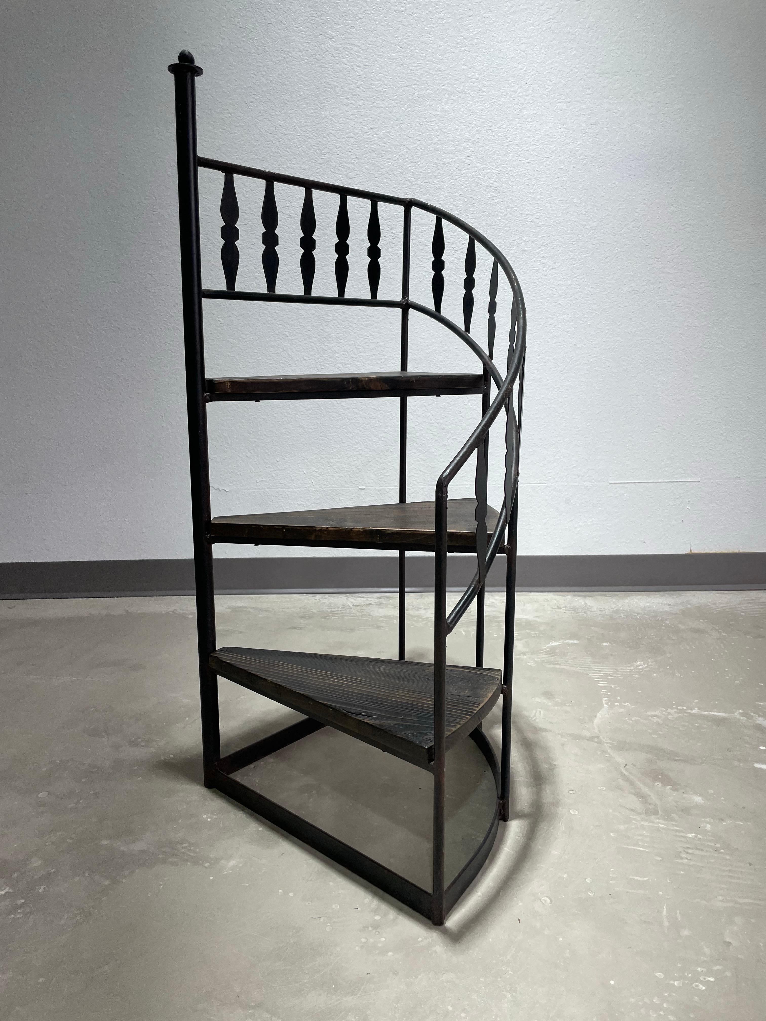 Mid Century Arthur Umanoff for Shaver Howard spiral staircase plant/decor stand. Wrought Iron with wood steps, 20” x 20” x 42”H. The perfect accent piece for your plants, books, and decor. As seen in the 1968-69 Shaver Howard catalog.

Some