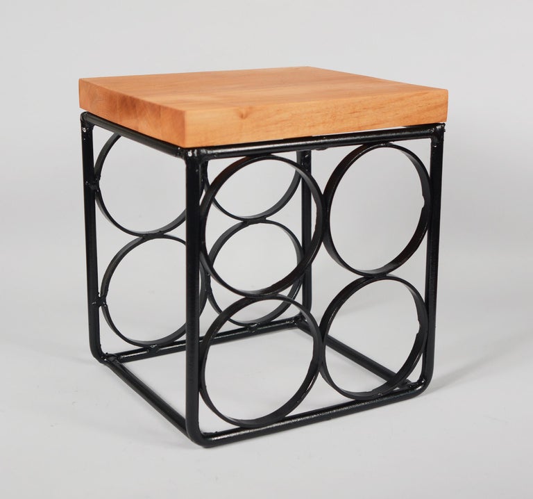 Small four bottle iron wine rack by Arthur Umanoff. This has a oiled cutting board style top.