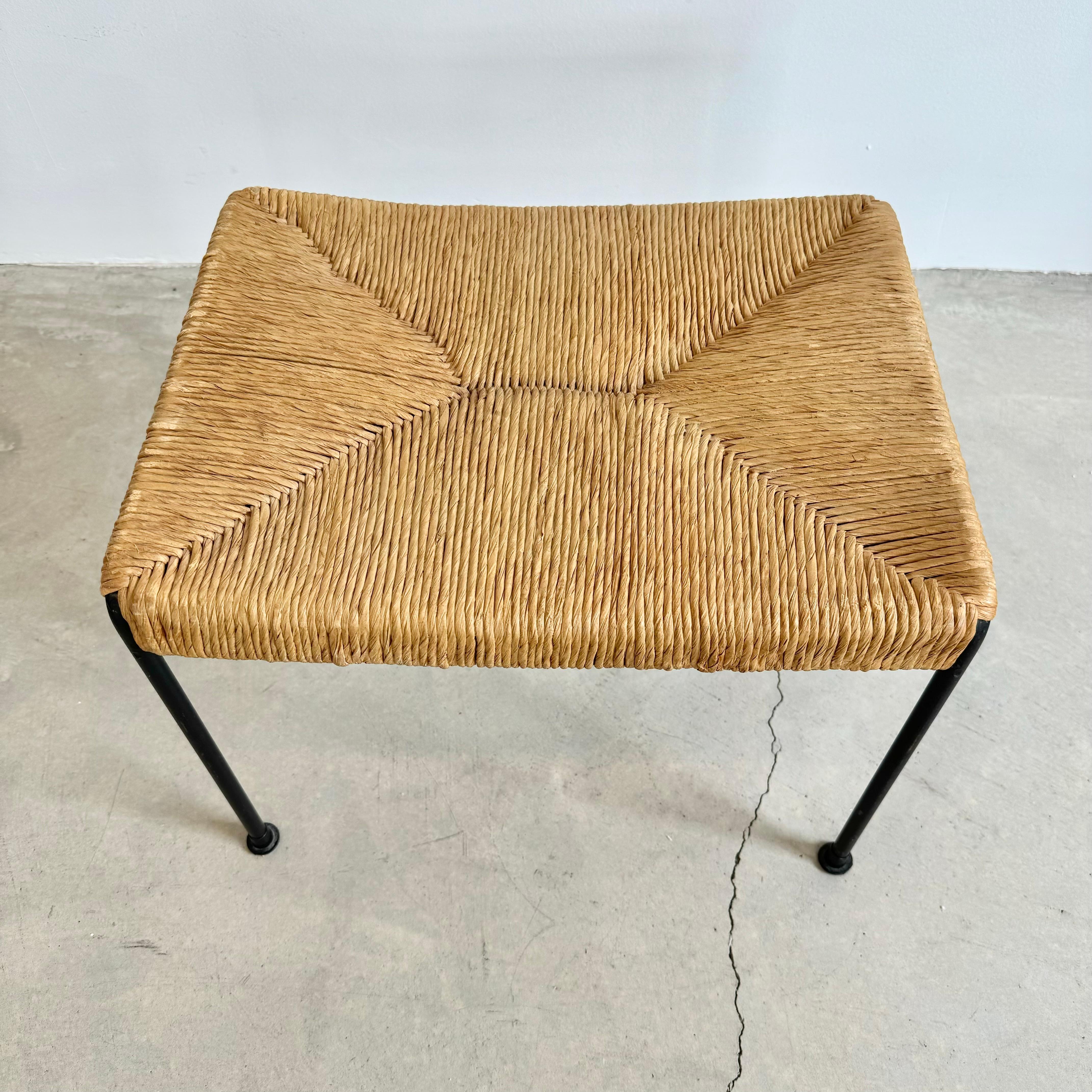 Sculptural Arthur Umanoff stool with signature rush seat supported by an iron frame. Iron is painted in a vintage black. Good vintage condition. Only one available. 

Located in our Los Angeles showroom.