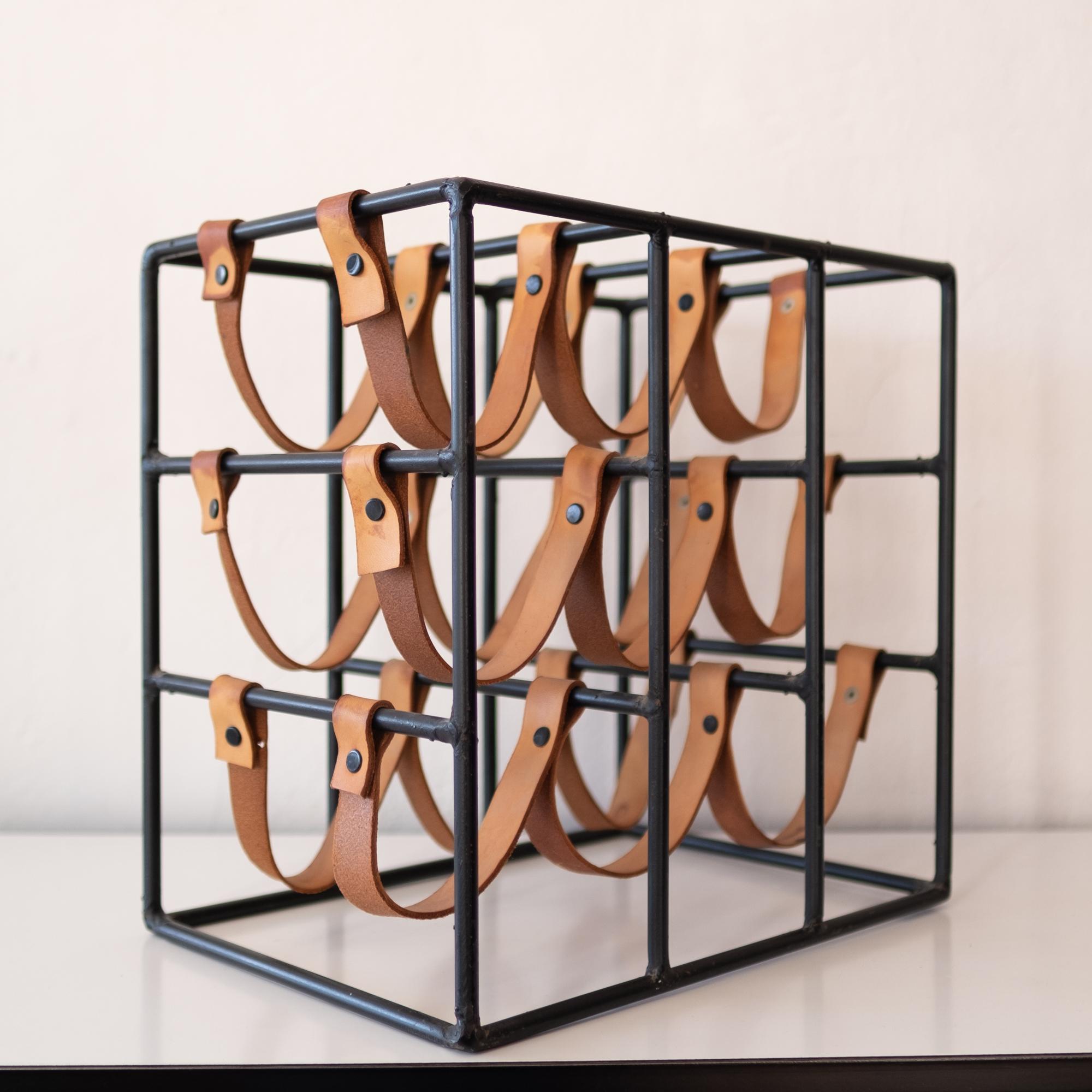Leather and iron wine rack by Arthur Umanoff for Shaver Howard. It holds 9 bottles.