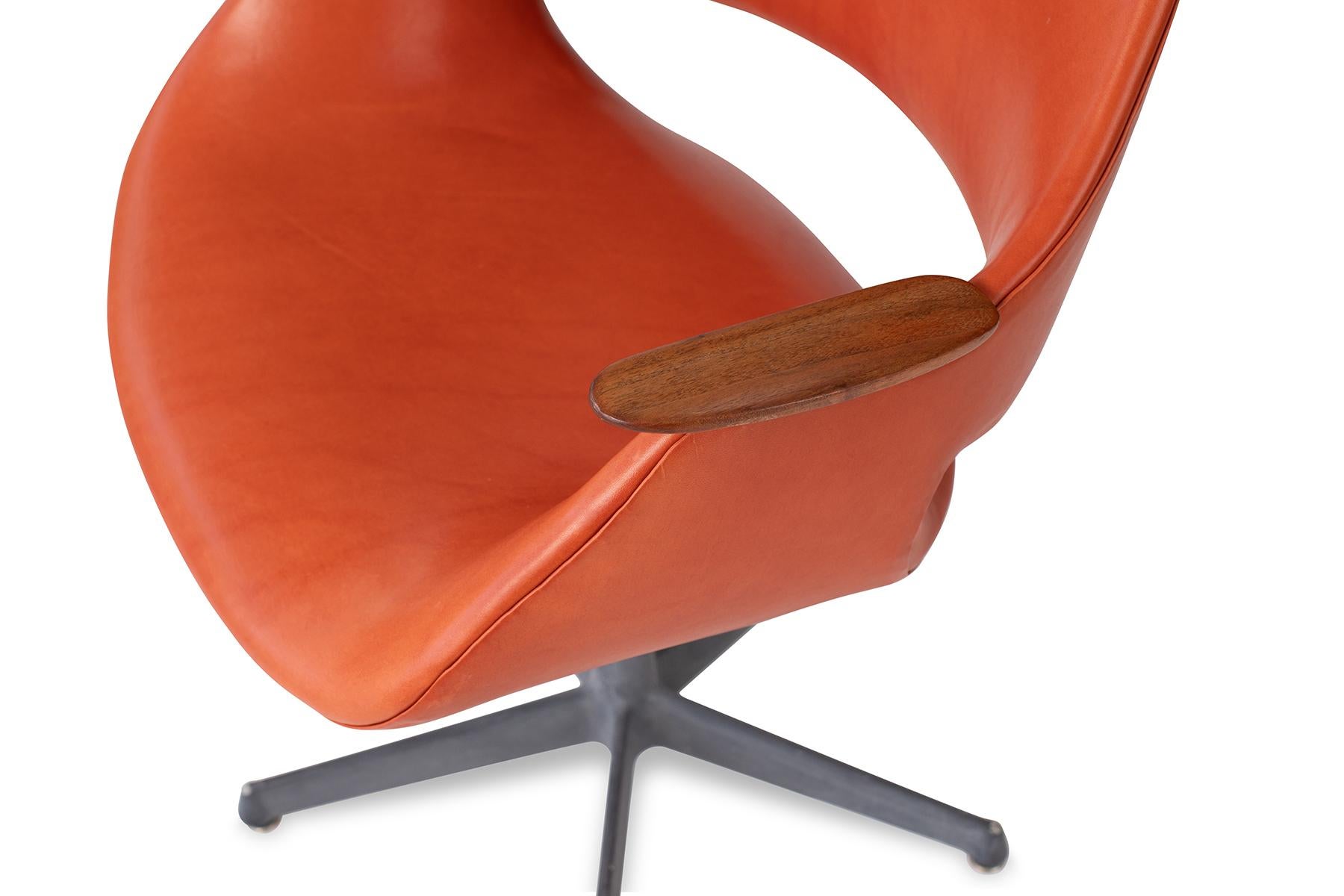 Arthur Umanoff leather steel and walnut chair, circa late 1960s. This example has been newly upholstered in a persimmon leather and the walnut arms refinished. Metal base retains patina. Size: Arm height is 25
