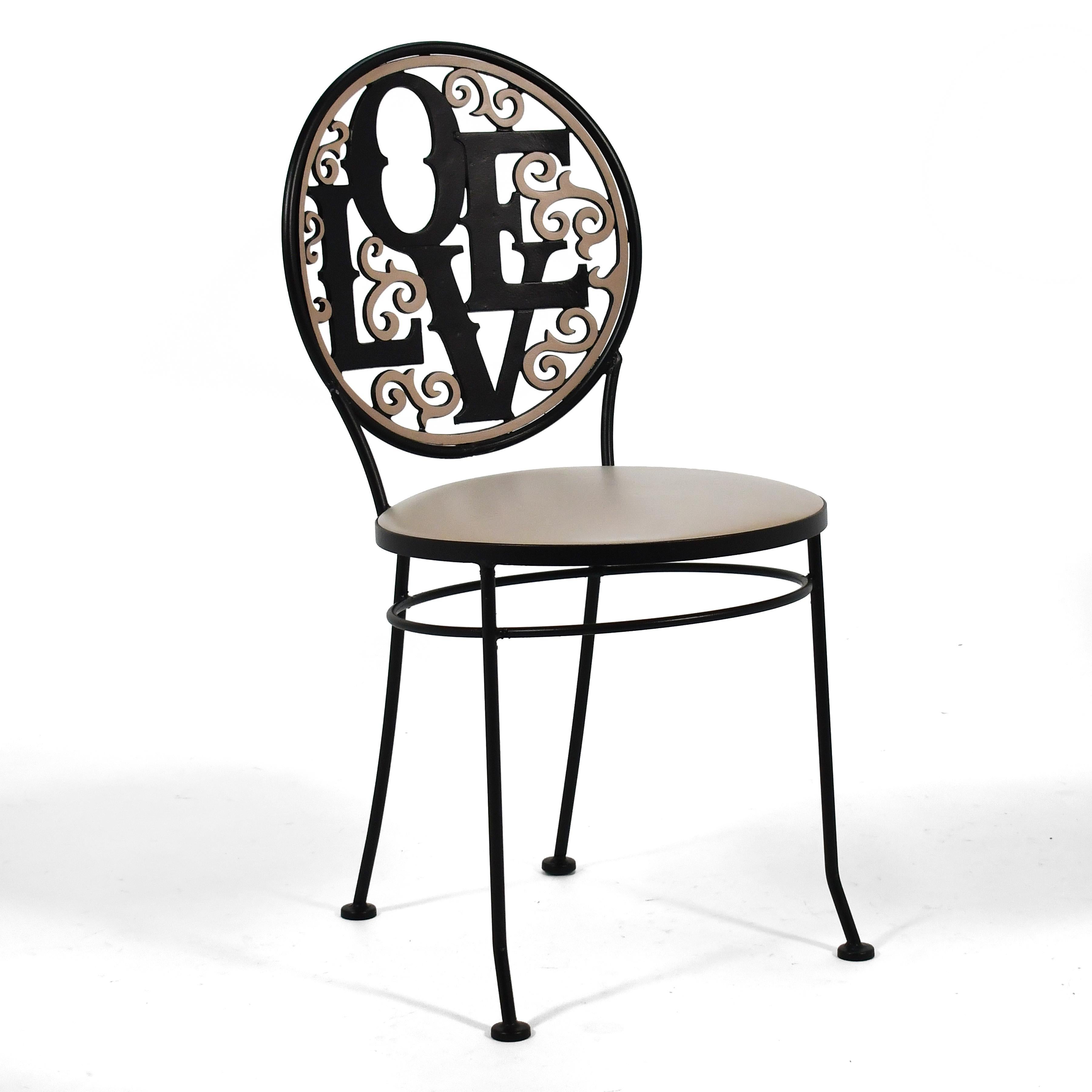 A joyful design by designer Arthur Umanoff who created many delightful works in modest materials for Shaver Howard. This wrought iron chair has a back with a playful cast design that name-checks Robert Indiana.
