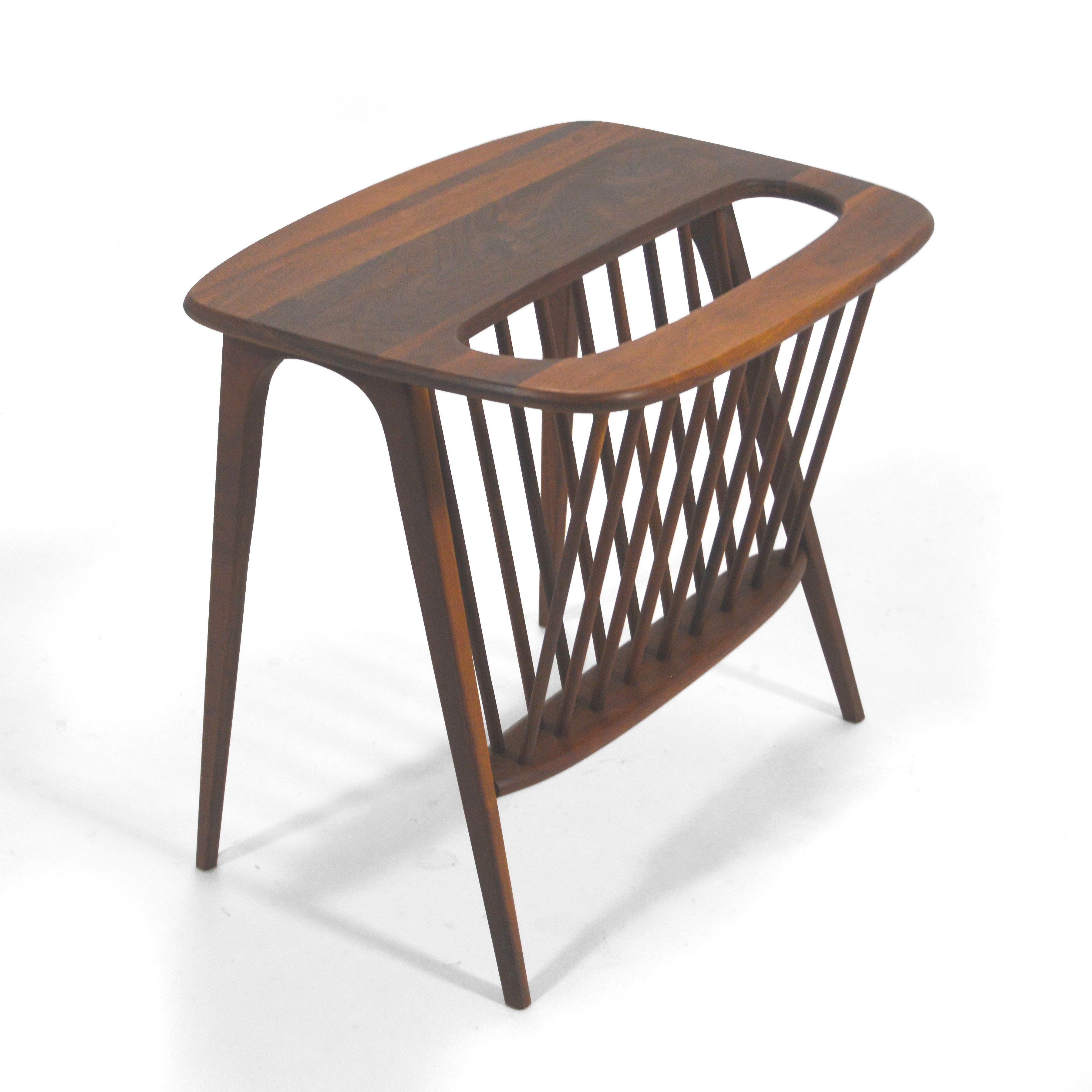 A beautiful design that is also very practical, Umanoff’s design is a side or end table with an integrated magazine rack. Crafted of rich walnut, the sculptural form has a visual lightness that is a hallmark of midcentury design.
