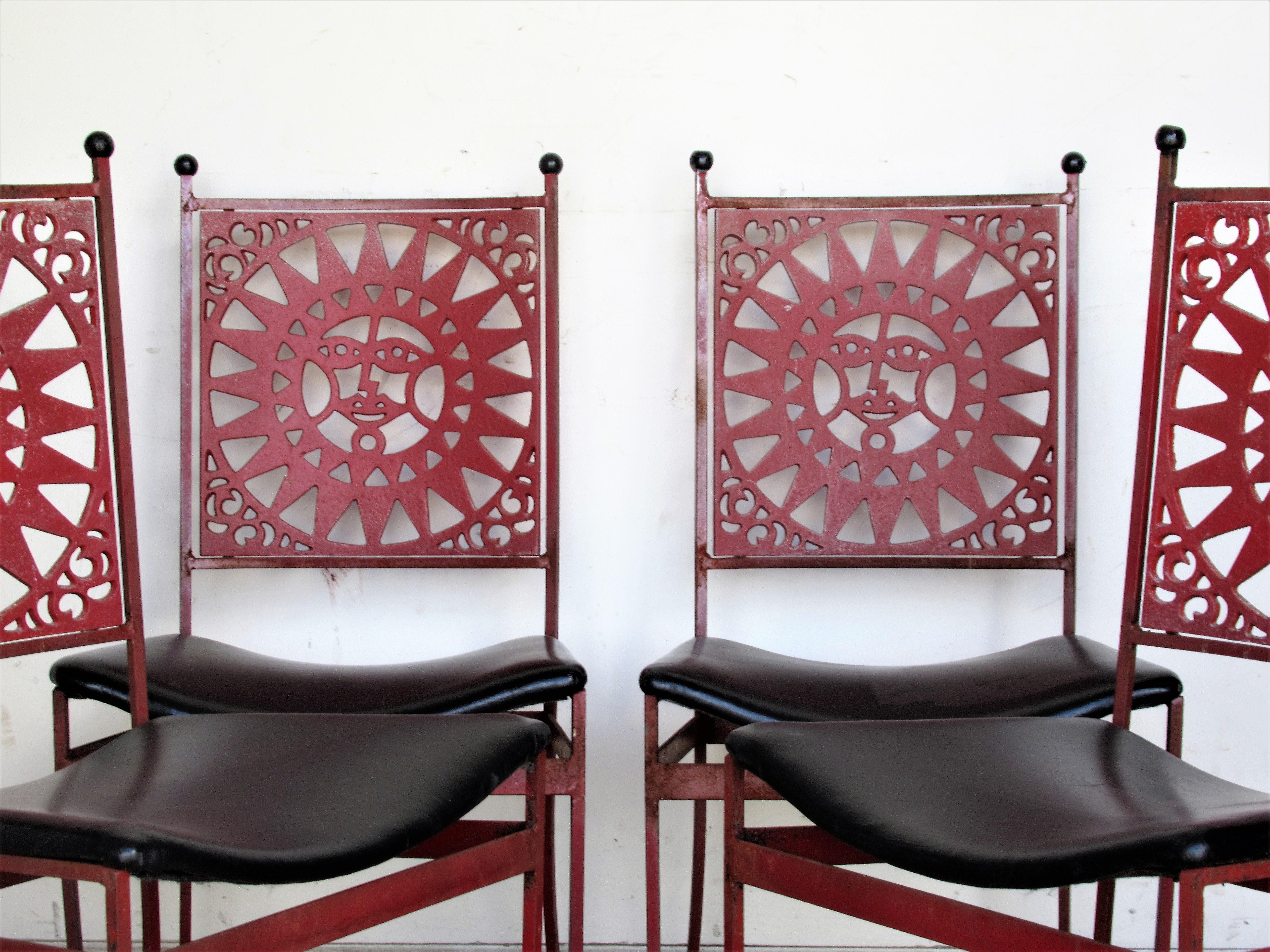 A matched set of four Mayan sunburst back iron dining chairs by Arthur Umanoff for Shaver Howard with all original chinese red painted surface and contoured black vinyl seats, circa 1960. Look at all pictures and read condition report in comment