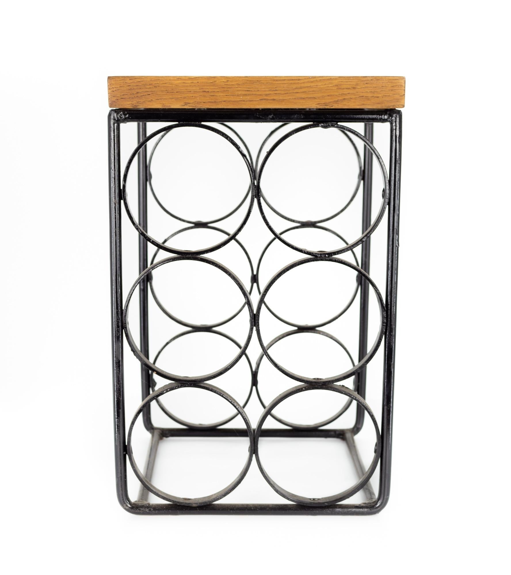 Arthur Umanoff mid century iron wine rack

The wine rack measures: 8.75 wide x 7.75 deep x 13.75 inches high 

This set is in Great Vintage Condition with minor wear.

We take our photos in a controlled lighting studio to show as much detail