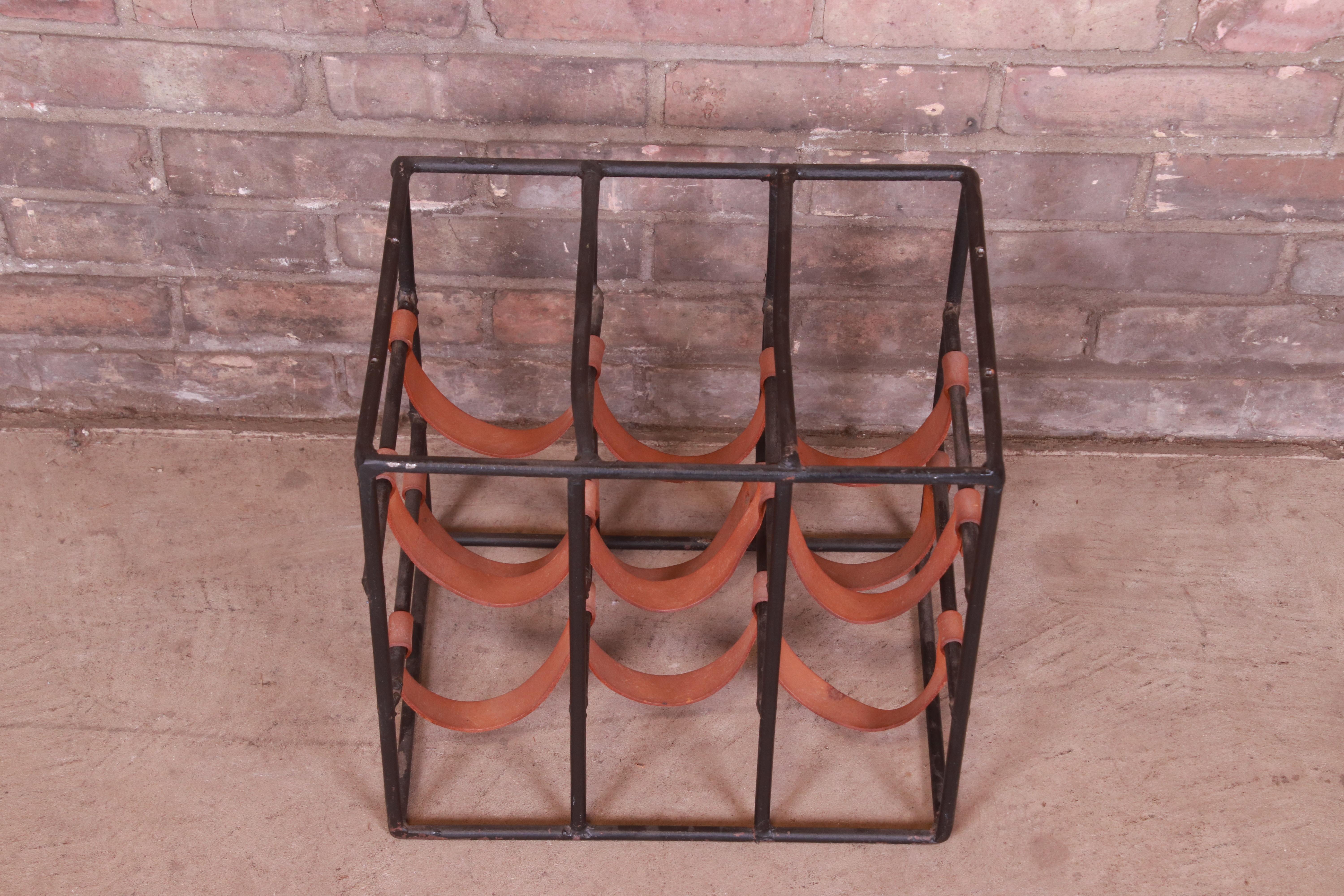 A beautiful Mid-Century Modern wrought iron and leather table top wine rack

By Arthur Umanoff for Shaver Howard

USA, Circa 1950s

Measures: 13.75 x 10 x 13.75

Very good original vintage condition.