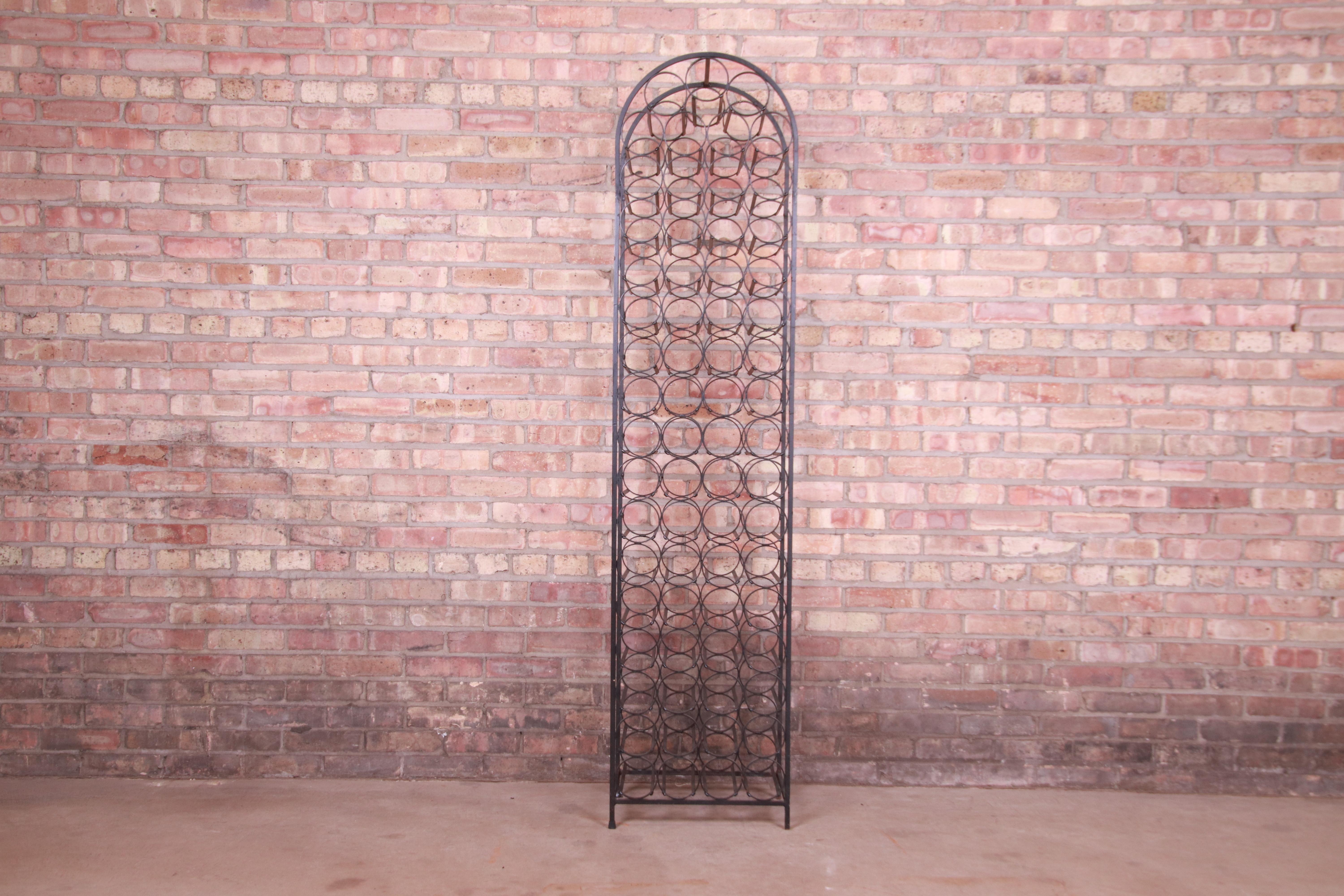A beautiful Mid-Century Modern wrought iron arched 71-bottle wine rack

By Arthur Umanoff for Shaver Howard

USA, Circa 1950s

Measures: 16.75