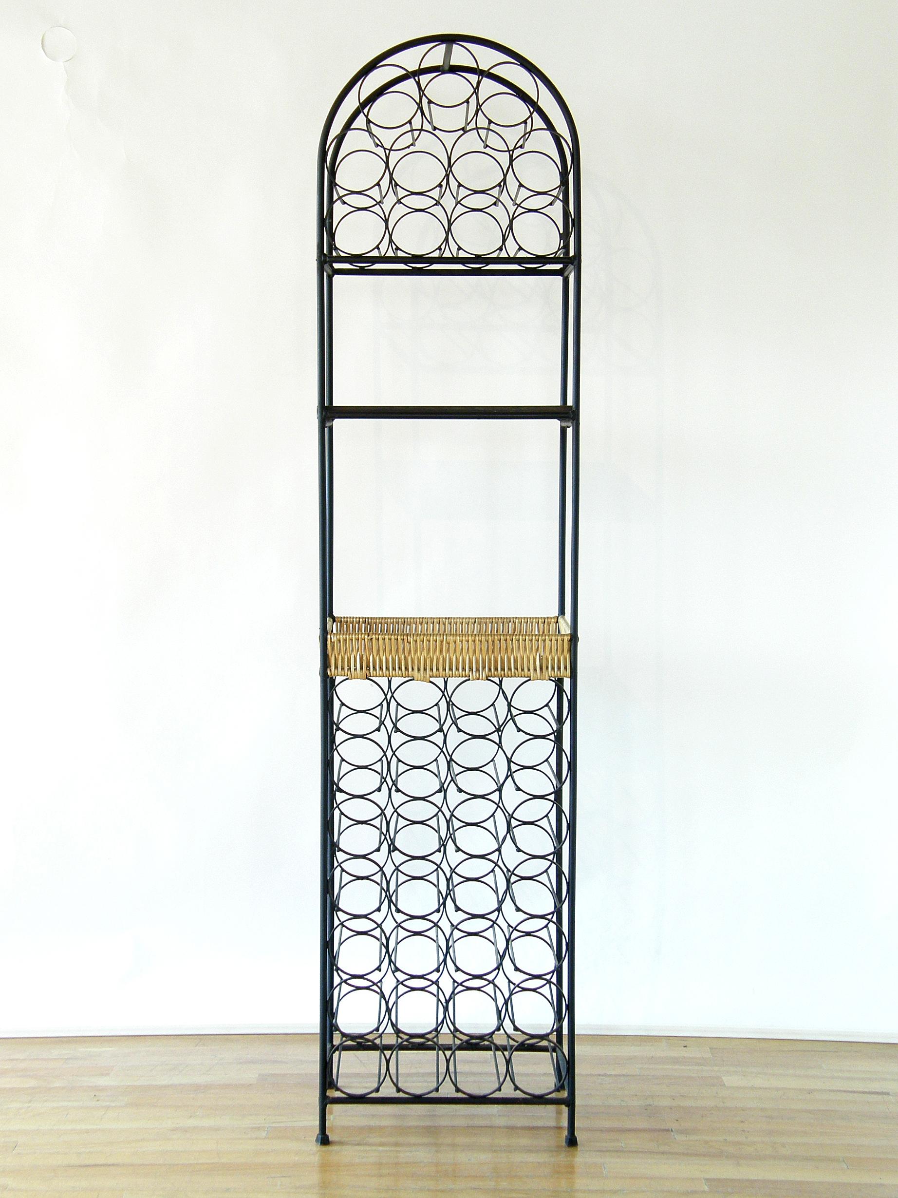 This compact wine rack with cocktail bar/serving area was designed by Arthur Umanoff for Shaver Howard. The design provides a large amount of bottle storage with a very small footprint, and the two laminated shelves offer a little area for mixing