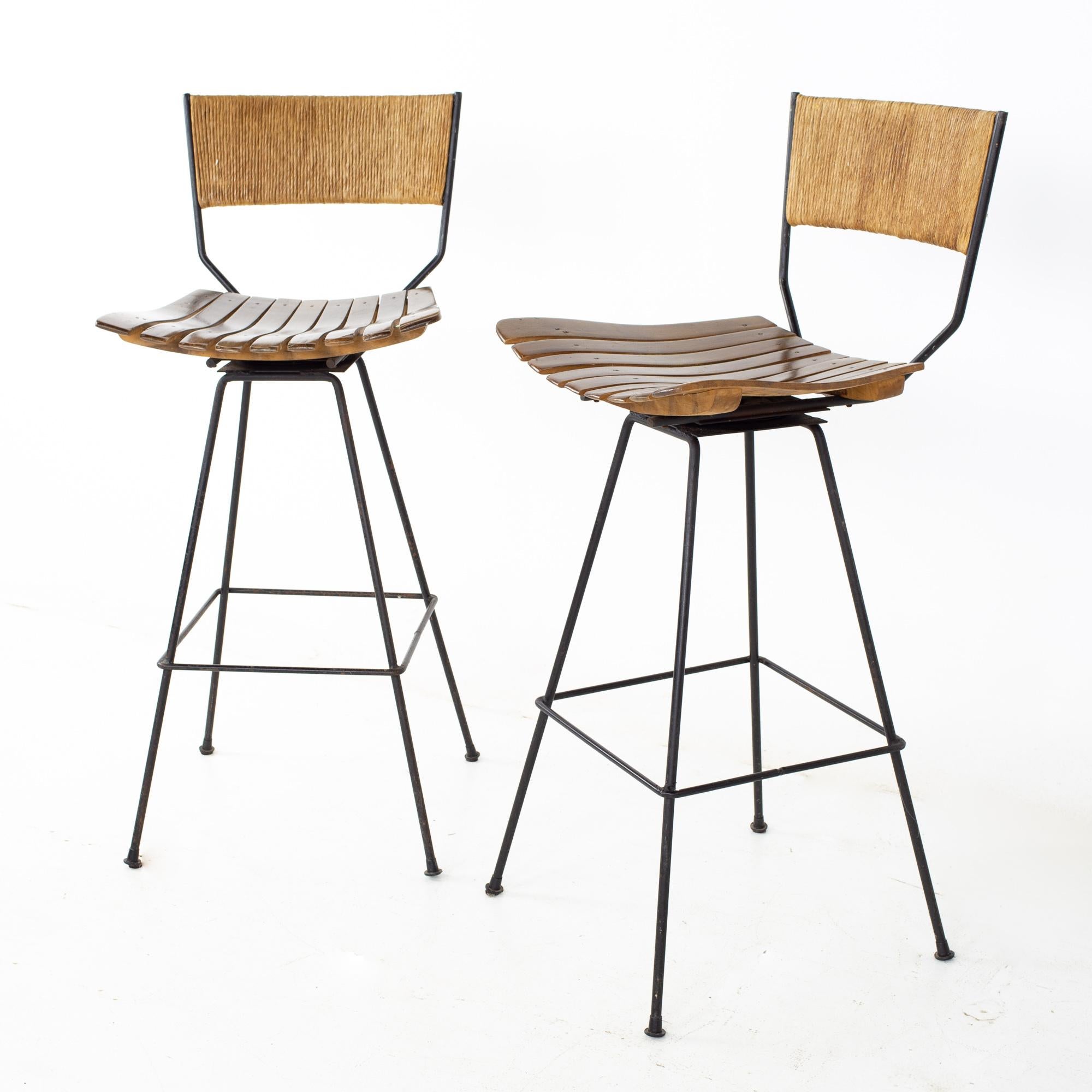Arthur Umanoff mid century roped wood and iron bar stools - a pair
Each stool measures: 18 wide x 18 deep x 40.5 high, with a seat height of 30.5 inches

All pieces of furniture can be had in what we call restored vintage condition. That means