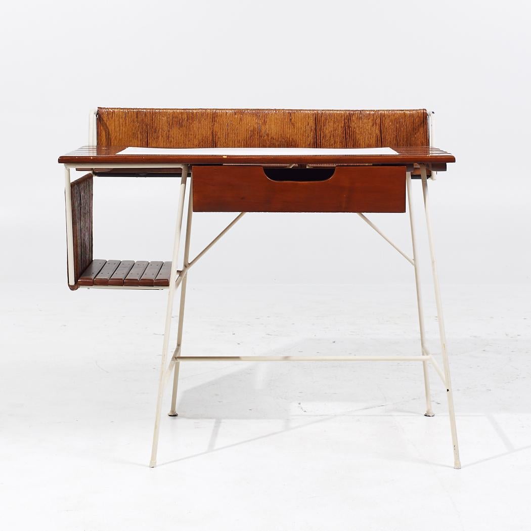 Arthur Umanoff Mid Century Wrought Iron and Rush Desk

This desk measures: 37.5 wide x 22.25 deep x 29.25 high to the work surface; 33.75 inches high to the top edge, with a chair clearance of 24 inches

All pieces of furniture can be had in what we