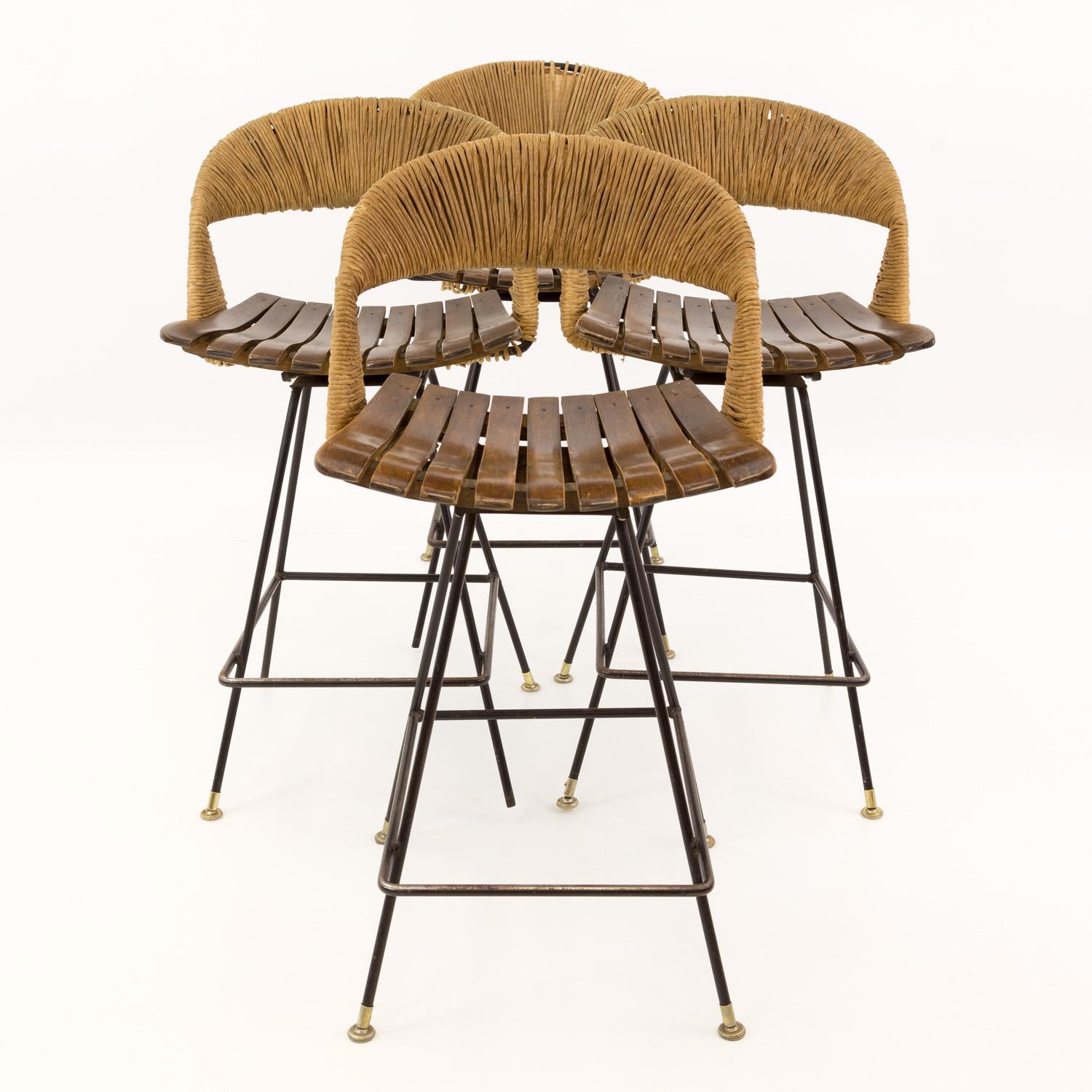 Arthur Umanoff Mid Century Tiki iron bar stools - Set of 4
Each stool is 18.5 wide x 20 deep x 35 high with a seat height of 25 inches

All pieces of furniture can be had in what we call restored vintage condition. This means the piece is restored