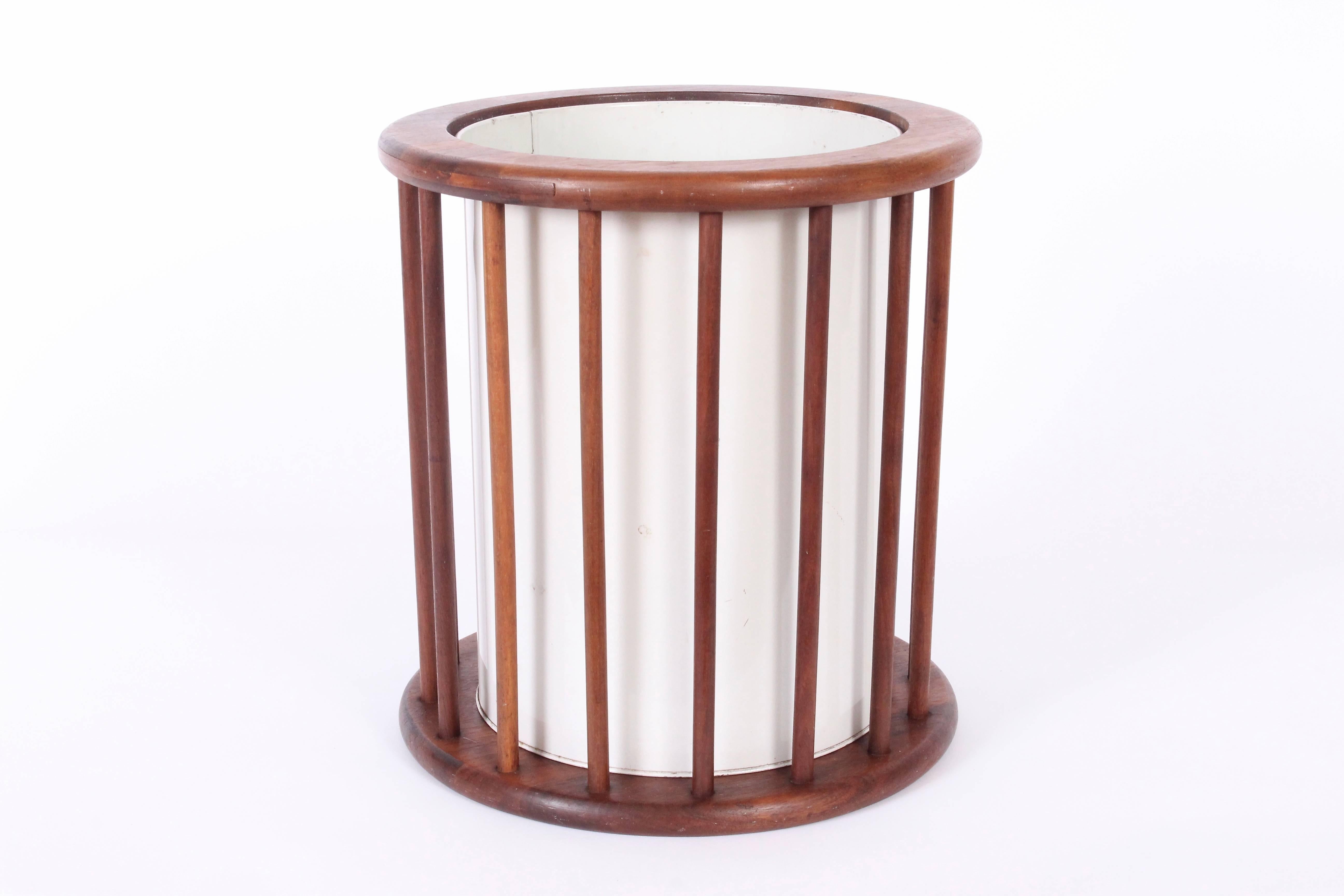 American Mid Century Modern Arthur Umanoff Walnut Spindle Paper Can, Trash Basket. Circular Walnut spindle surround with Off-White enameled liner can for easy removal. Original condition. Metal container 9D. Versatile. Sculptural. Rarity. 
