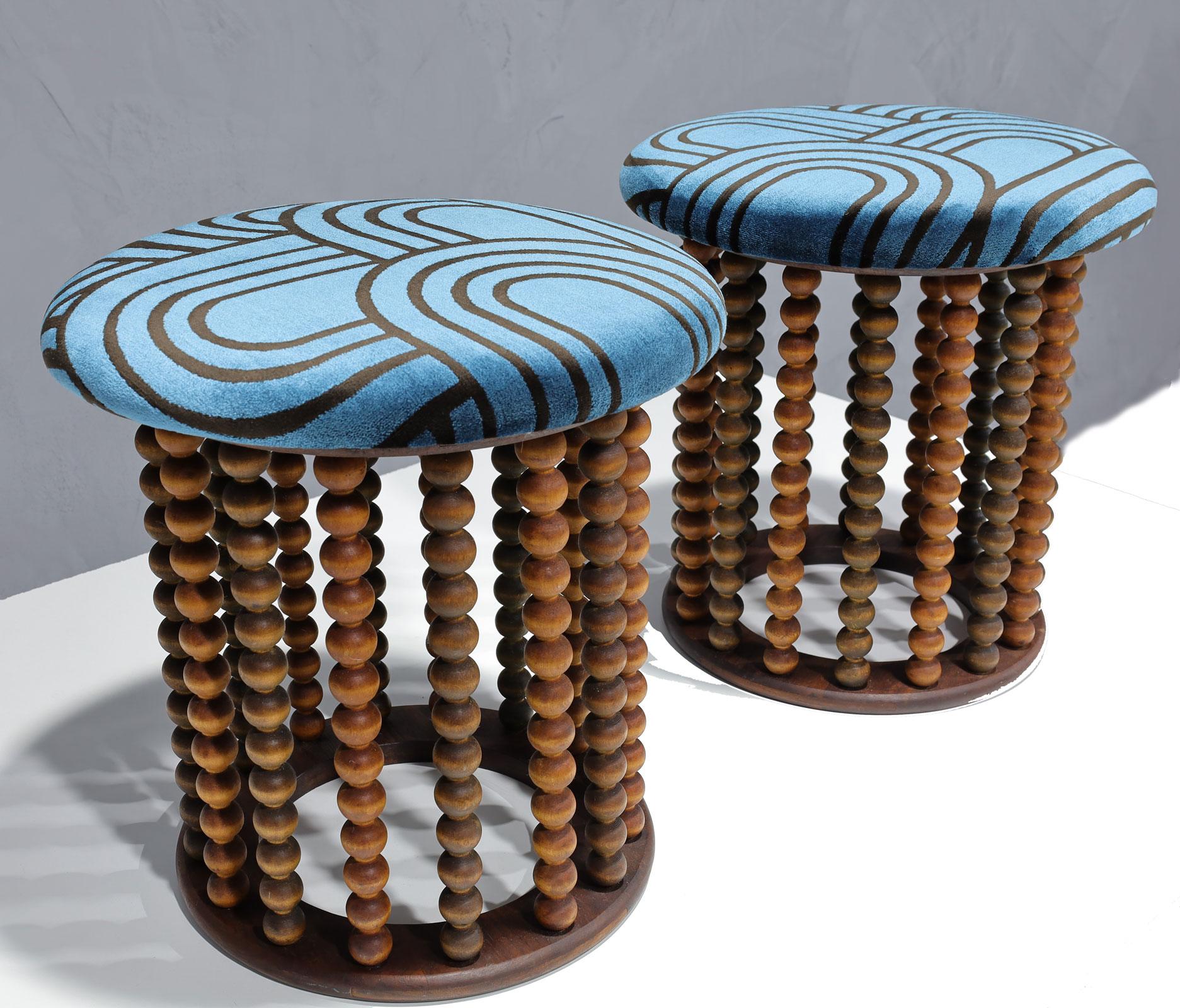 This is a unique pair of stools with beaded carved wood supports. Made by Washington Wood Products in New Jersey. Newly upholstered in a velvet.