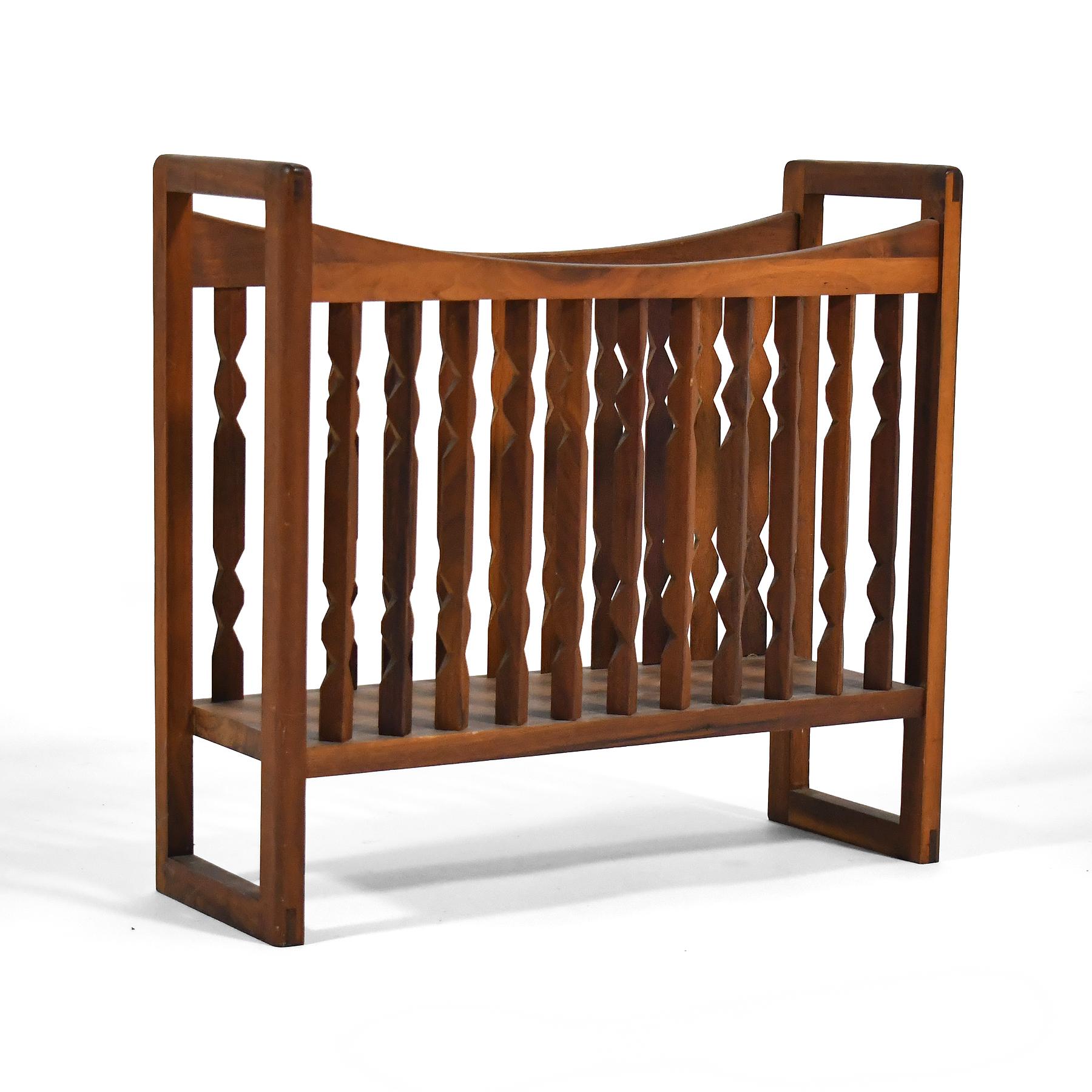 This lovely walnut magazine rack by Arthur Umanoff for Washington Woodcraft has sculptural spindles that create visual movement as your perspective on the piece changes.

18.5