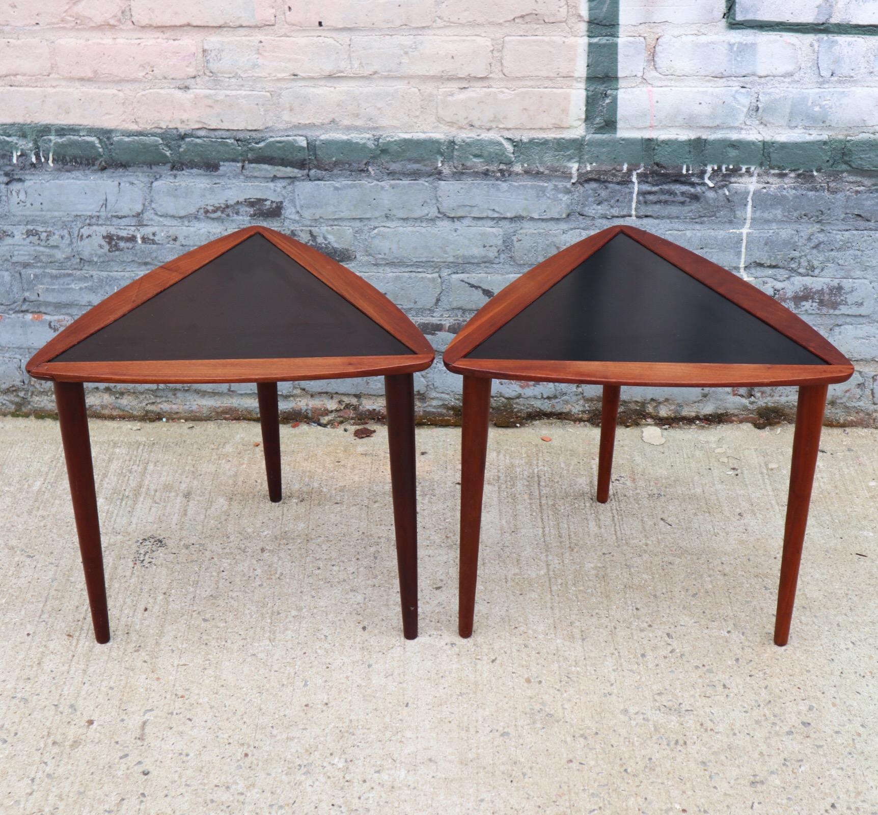 Arthur Umanoff walnut stacking tables. Formica black tops in great shape and walnut surfaces have been freshly oiled. Gorgeous deep color and elegant design make these perfectly suited to match all styles of decor. 1 table with reglued pieces to