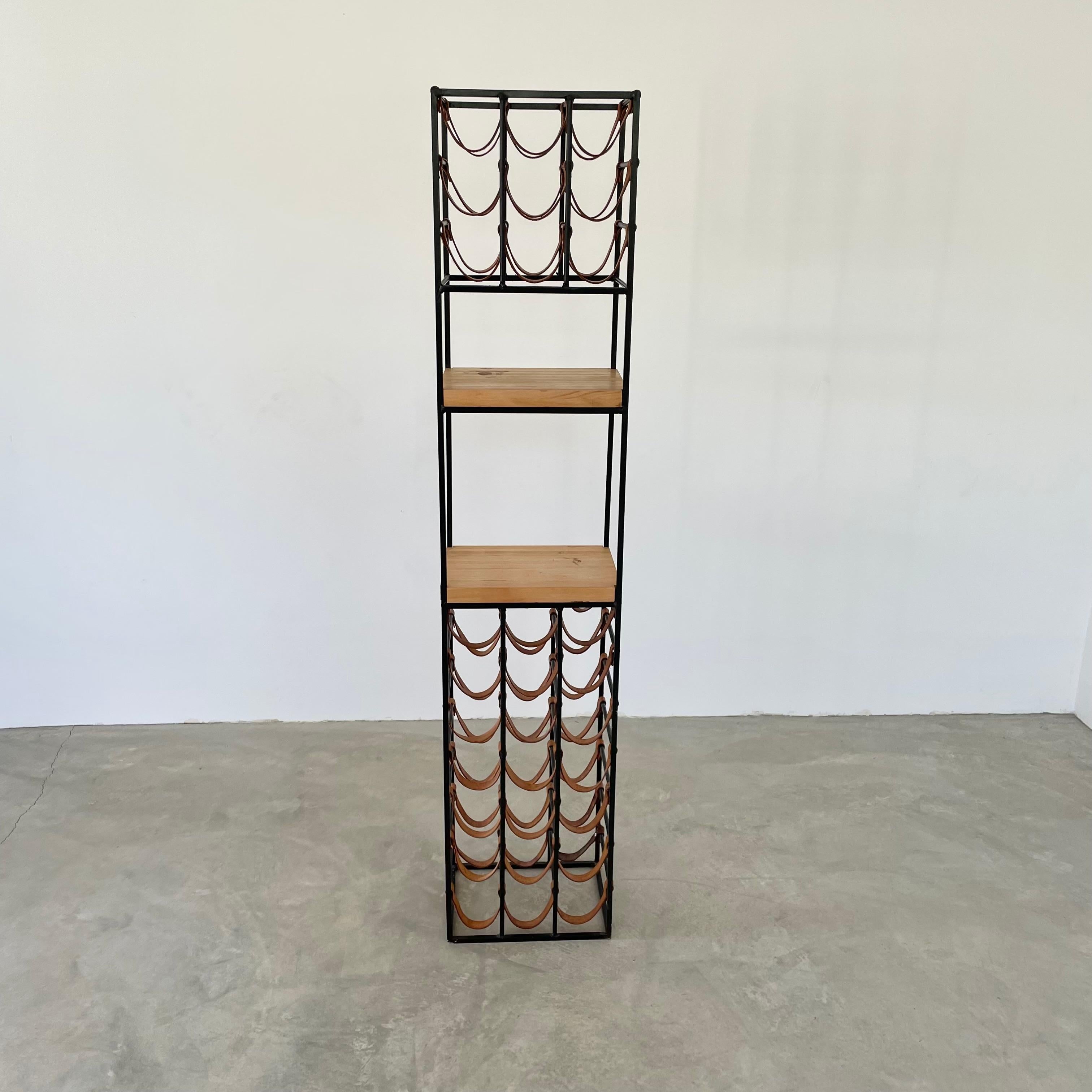 Gorgeous iron and leather wine rack by Arthur Umanoff. Solid iron frame with two butcher block shelves. Saddle leather straps hold 30 bottles. Lower shelf can hold an additional nine bottles comfortably. Great piece for your kitchen or dining room.