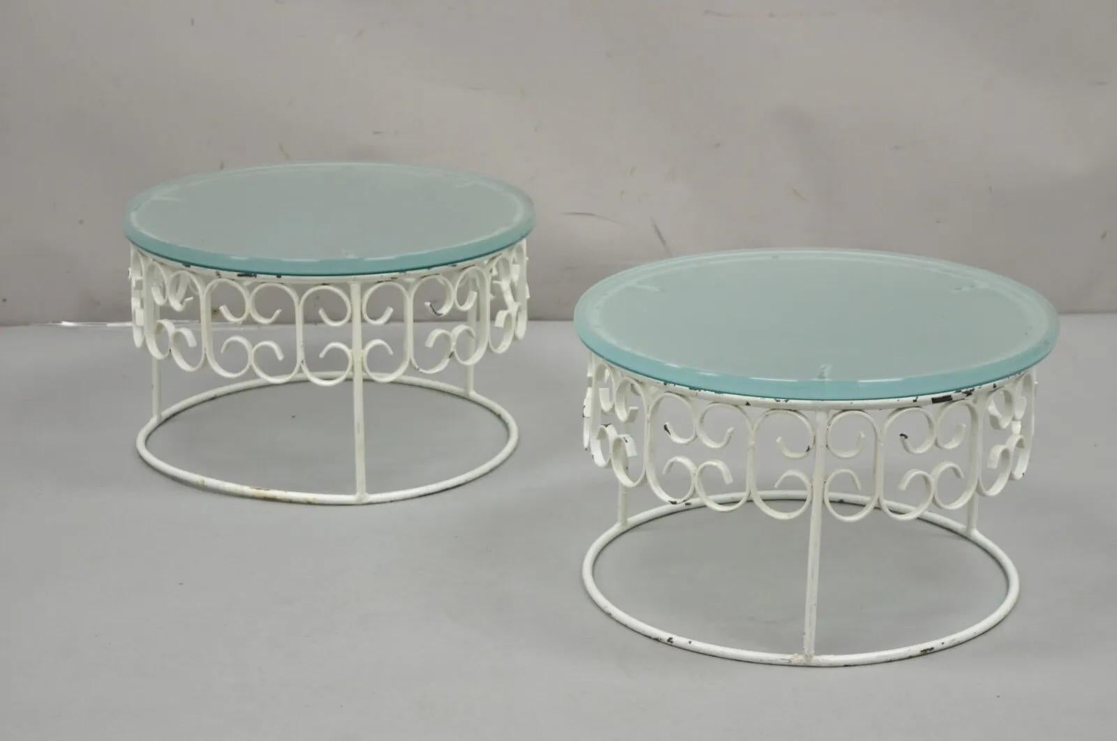 Vintage Arthur Umanoff Wrought Iron Scroll Low Round Glass Top Side Tables - a Pair. Item features thick round frosted glass tops, wrought iron round bases, nice unique low form. Circa 1960s. Measurements: 11