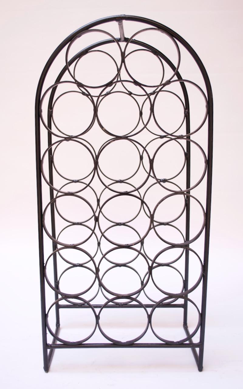 1950s Arthur Umanoff wine rack in painted wrought iron. Can be used as a tabletop or floor rack, accommodating 17 bottles.
Pictured with this wine rack is the smaller, 7-bottle holder (each sold separately).