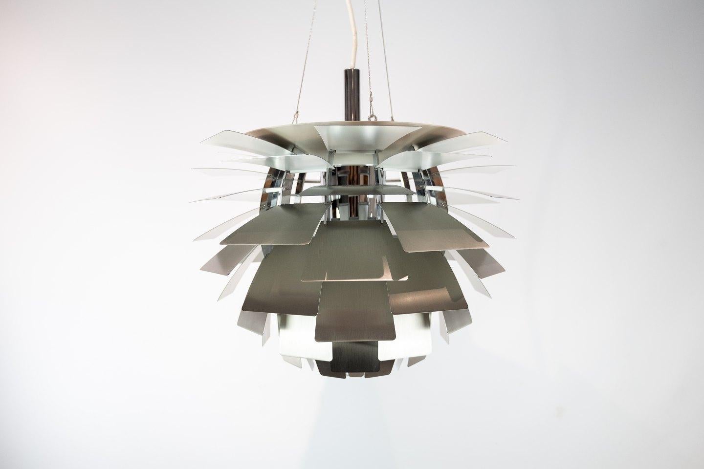 Artichoke, measures: Ø60, in brushed steel designed by Poul Henningsen in 1958 and manufactured by Louis Poulsen. The pendant is in great used condition from the 1980s. We have two in stock, which would be perfect at a larger dining area. 
 