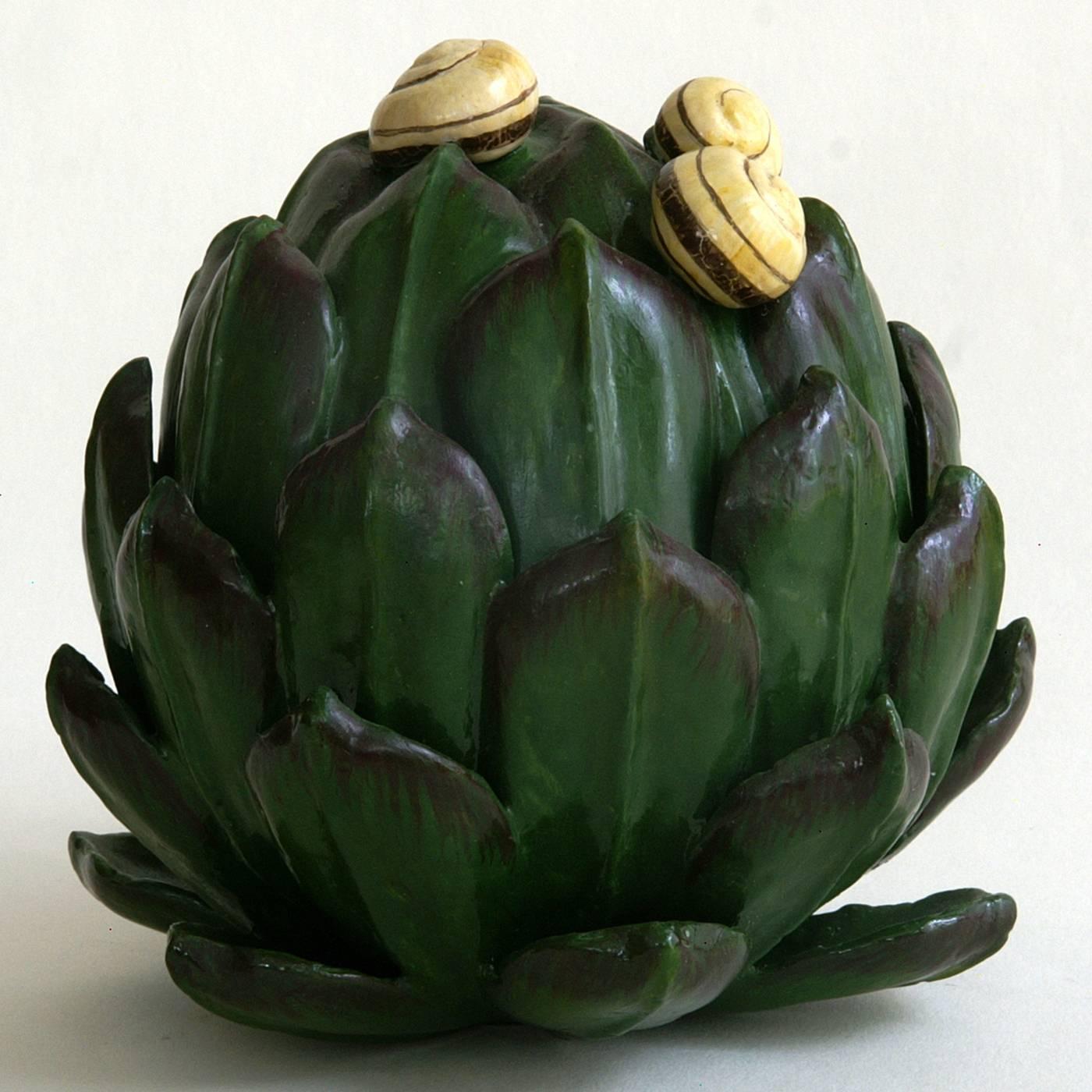 This exquisitely crafted papier-maché sculpture depicts an artichoke with small snails on the tips of its leaves. The artichoke is hand-painted with natural pigments in lifelike colors, and then lacquered giving its exterior a glossy finish. The