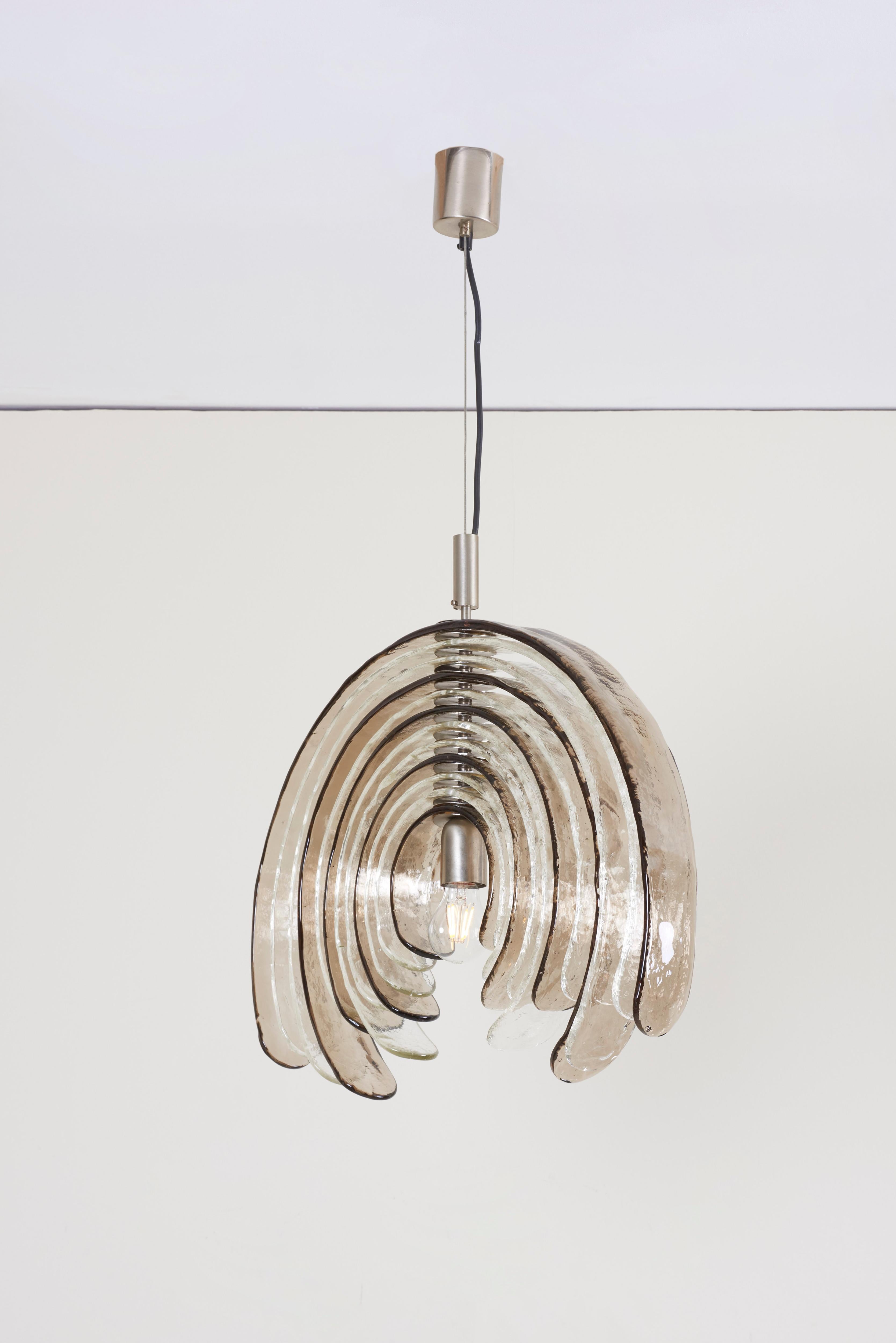 High-end sculptural artichoke chandelier by Carlo Nason for Mazzega. Thick clear and bronze textured glass blades. The blades can be put in the position of one line as unfolding into a flower. Illuminates beautifully. Perfect for a soft, warm and