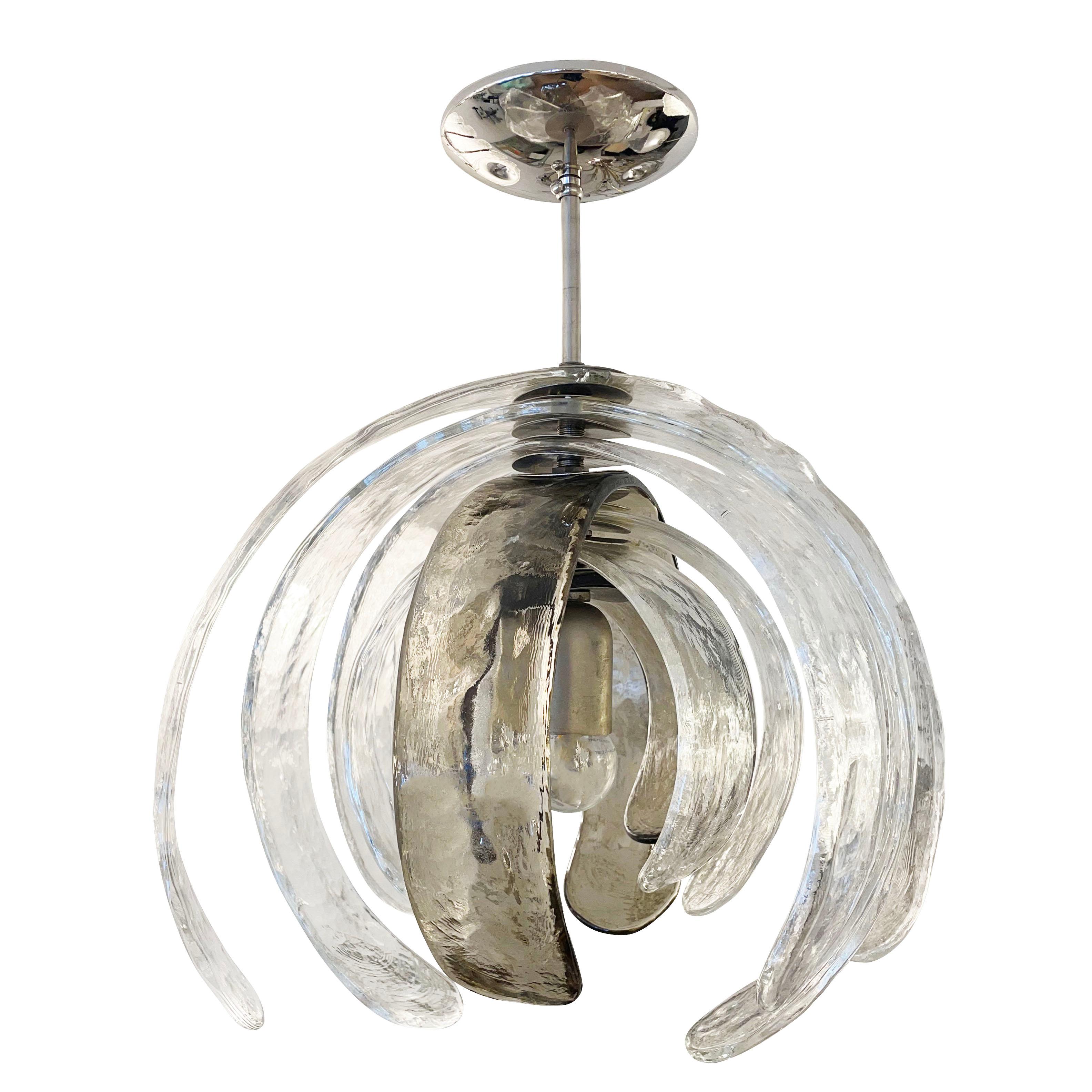 Sculptural Murano glass chandelier designed by Carlo Nason for Mazzega in the 1960s. It’s composed of several alternating clear and gray textured petal shaped glasses that can rotate around the center stem. Polished nickel hardware. Holds one