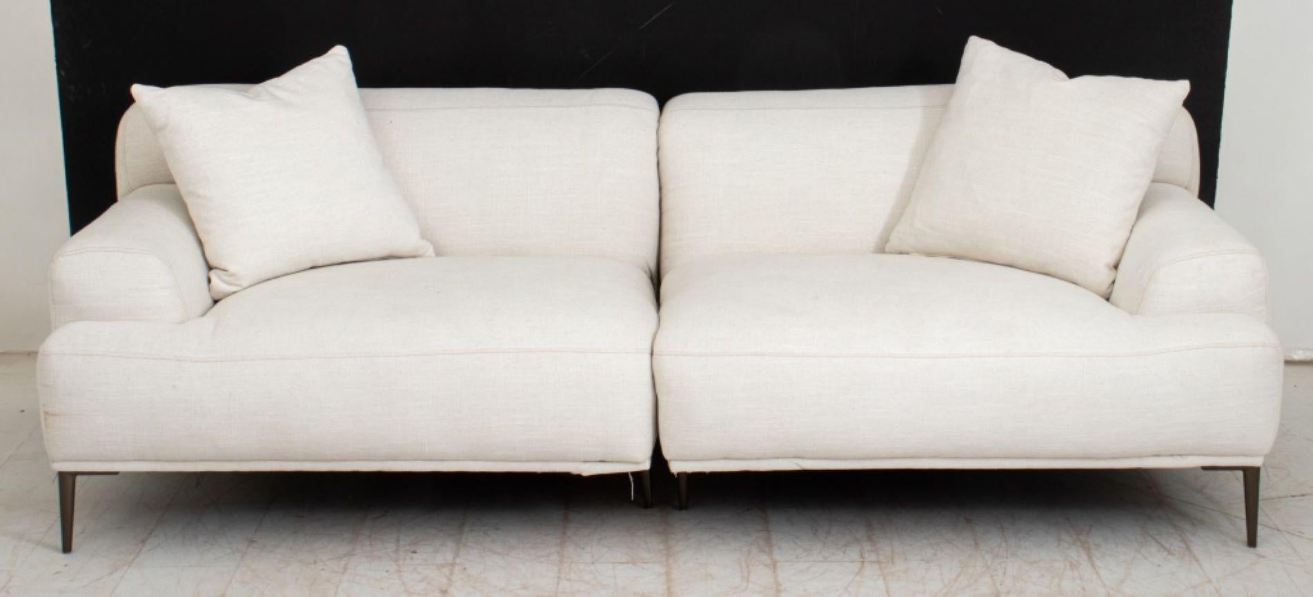 Article Abisko White Sofa, upholstered in cotton and linen blend fabric, with two pillows, in two pieces, labeled to left half underside. Sofa: 28