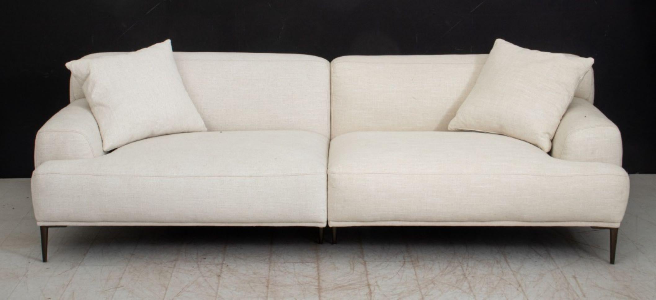 Article Abisko White Linen Blend Upholstered Sofa, with two pillows, in two pieces slotted together, label to underside of left half. 28