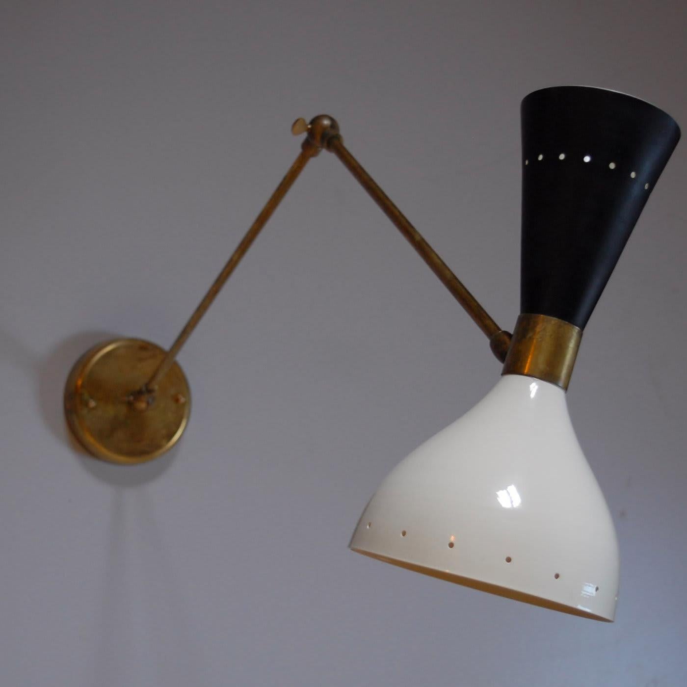 A dynamic addition to a modern home, this sconce can be an accent piece in an entryway, or in pair flank a mirror or a sofa in a living room. Its brass structure features two moving joints and a third operated by a thumb key. The base can move at a