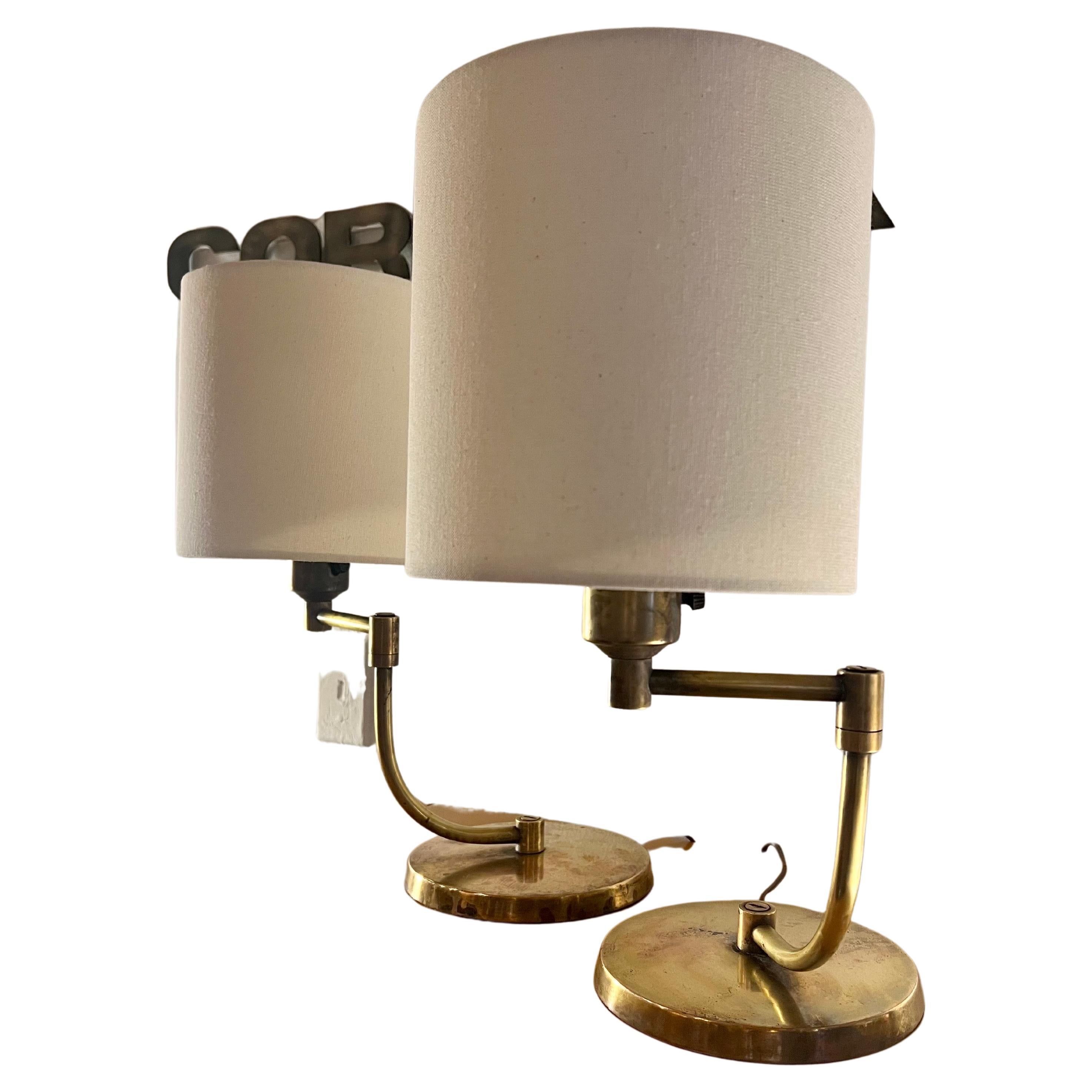 Fantastic Pair of patinated Brass table lamps attributed To Walter Von Nessen, circa 1940's articulated arm that swivels 360 degrees with freshly new redone shades, freshly rewired and left the original glass shades, great style design, and