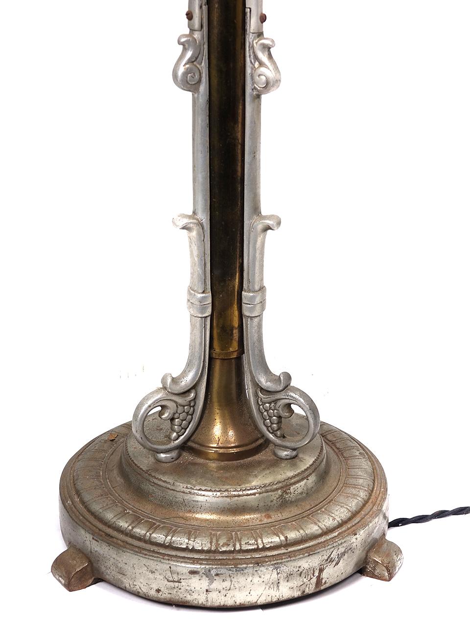 This is a nice and very Art Deco floor lamp. It’s a combination of aluminum and brass with a milk glass shade. The lamp is unique because it telescopes up and down for reading. It is newly wired including a fresh toggle switch.