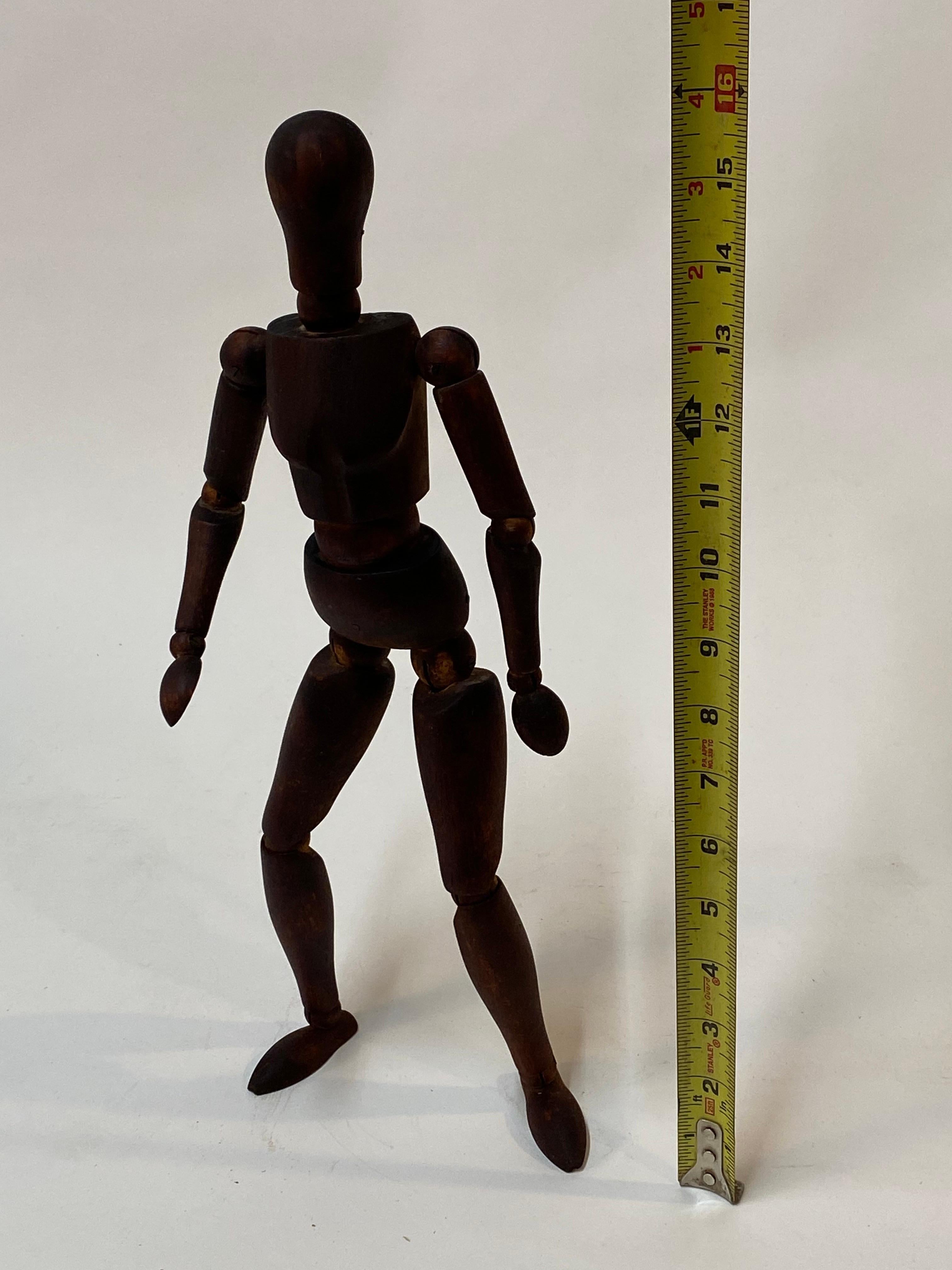 A wonderful vintage articulated wood artist's mannequin. A must have for the artist or objet d'art. The interior coils and bands that position the model are in good condition. The quality of this particular wood model is possibly French in origin.