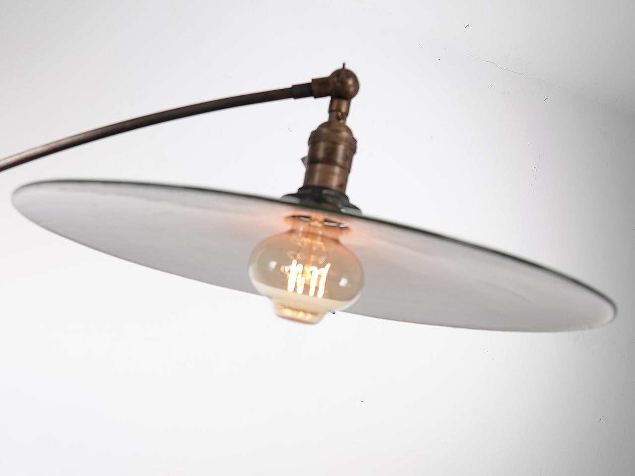 The lines on this lamp are beautiful. The base is delicate cast iron with 4 curved legs and small wooden wheels. The base also has a small rack to hold books... and it does make perfect reading light. The articulated arm that holds the lamp also has