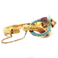 Articulated bracelet featuring a serpent and an eagle and gemstones and diamonds