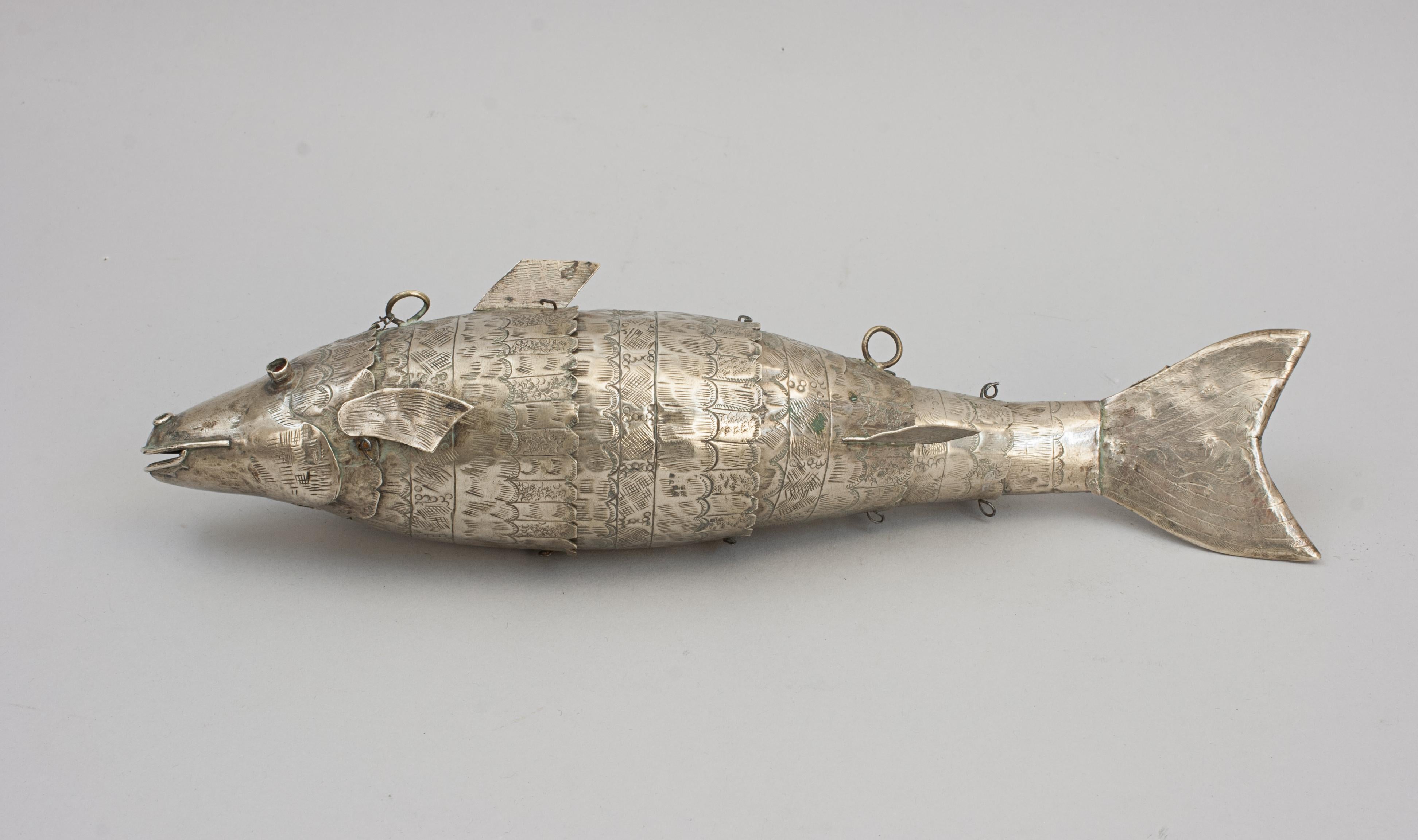 Articulated Metal Fish.
A late 19th/early 20th century metal articulated fish. The fish is made of plated brass, the head is connected to an articulated body with tail fin. The fish is made up of six moving parts with engraved scales. The fish is in