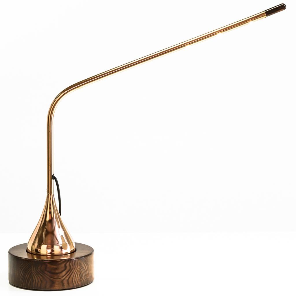 The modern articulated copper mortar & pestle light has a copper plated ball bottom with solid copper tube extension arm. This is set into a African Mahogany timber base with a connection that allows the light to articulate. This articulation makes