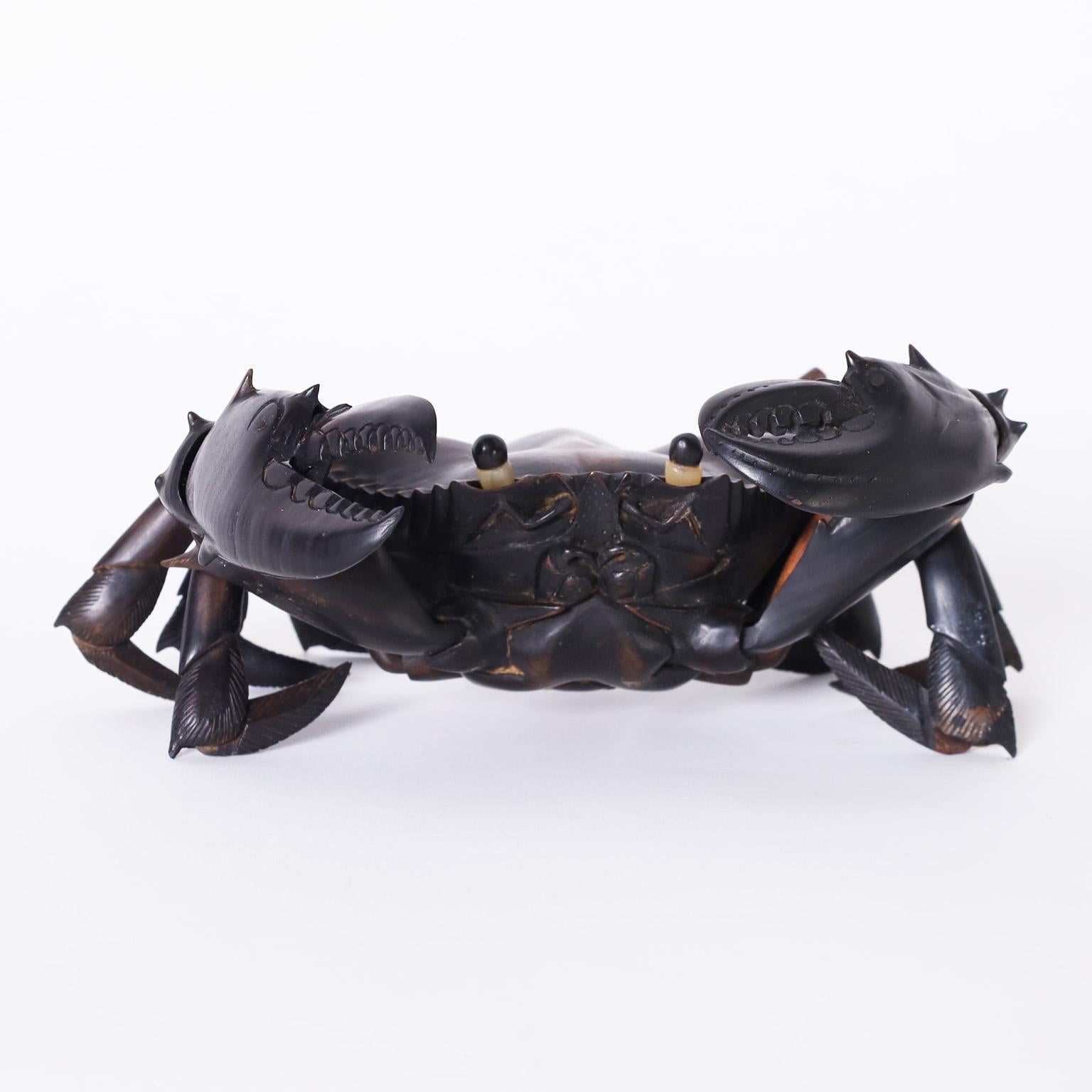 Rare life size, life like crab sculpture or object of art crafted in ebony with articulated joint movements and an assertive attitude.