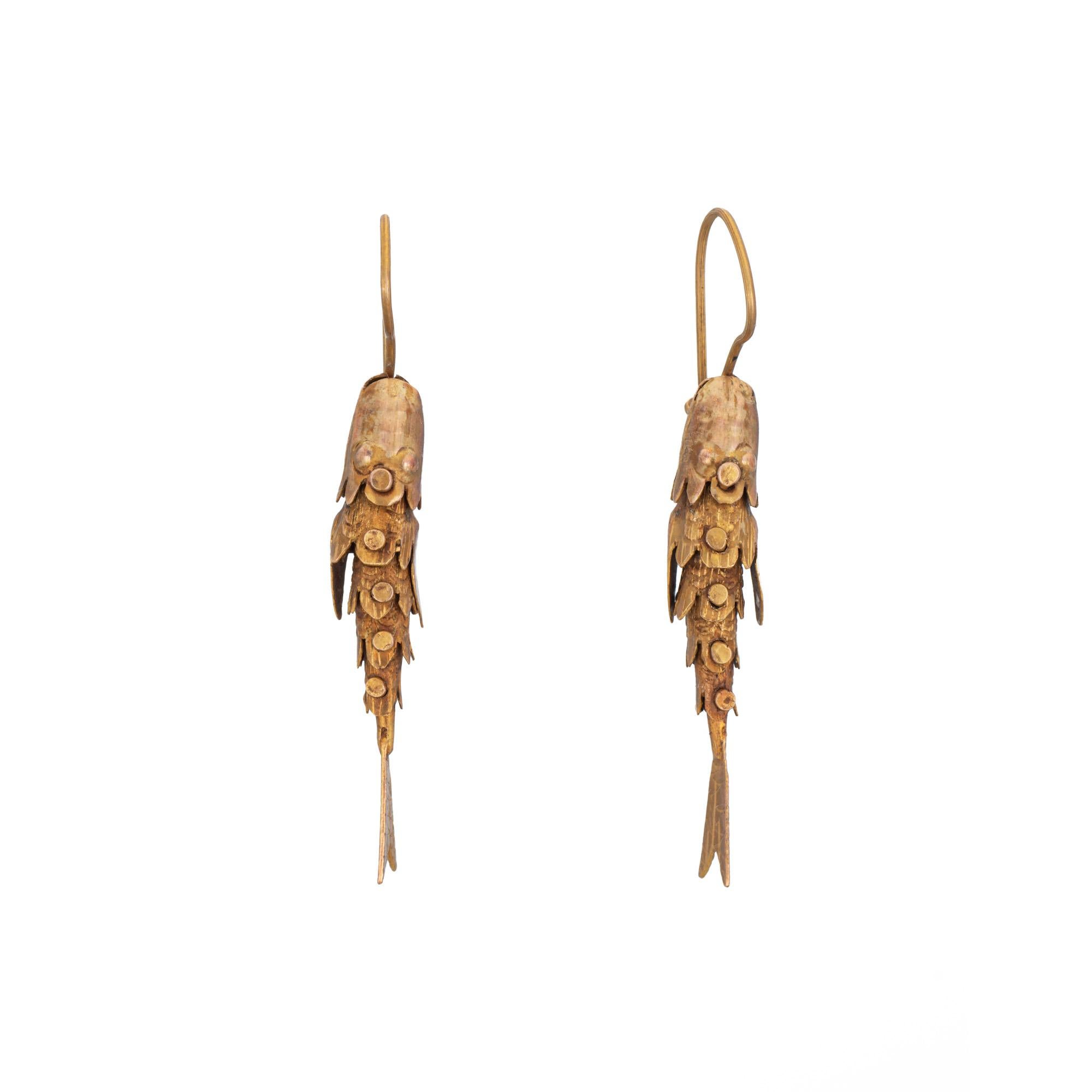 Stylish fish earrings crafted in 14k yellow gold (circa 1970s).

The playful earrings highlight an articulated design that captures the movement of a swimming fish. Petite in scale (measuring 1 inch) the earrings are great for day or evening wear.