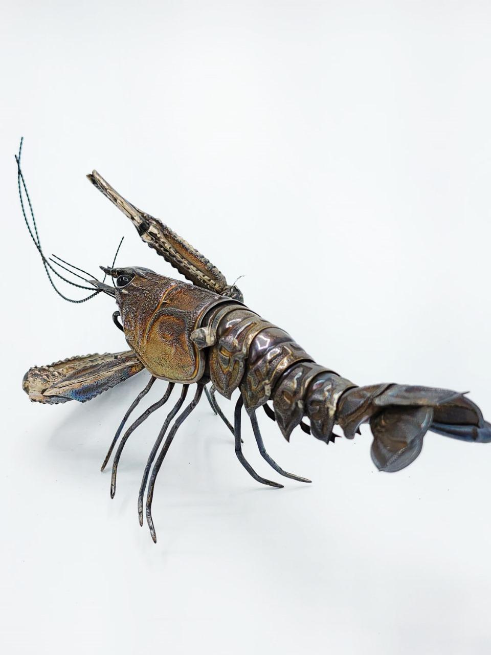 Articulated Spanish silver lobster.
This Art is called jizai okimono (which can be translated as decorative object that moves) are realistic figures of animals made of steel, copper, Shibuchi (a silver and copper alloy) and shakudo (copper and gold