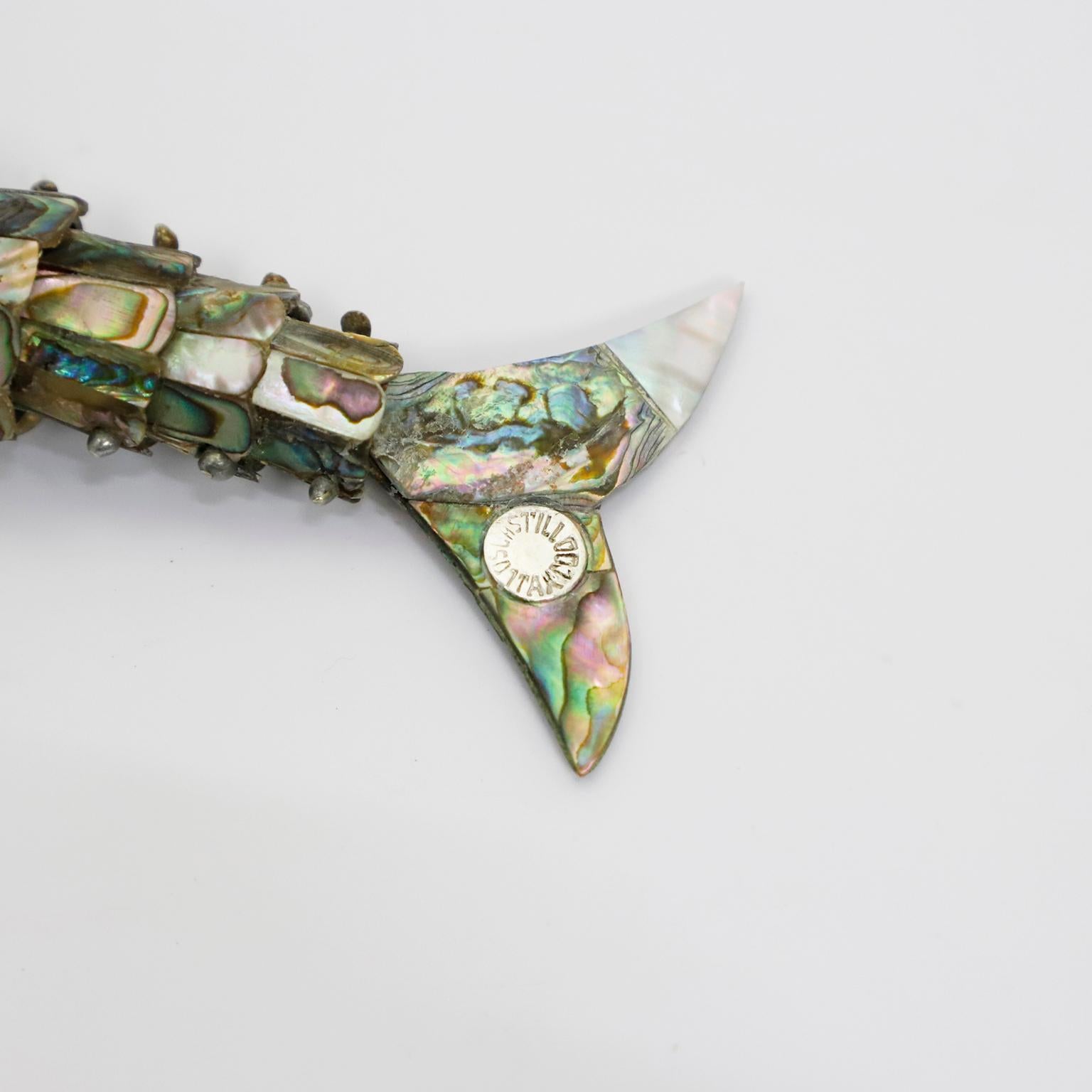 Beautiful vintage Mexican abalone shell and brass bottle opener in the form of fish by Los Castillo.
The mouth of the fish are made of brass which has a very nice aged patina. Made in Taxco Mexico, circa 1960s.