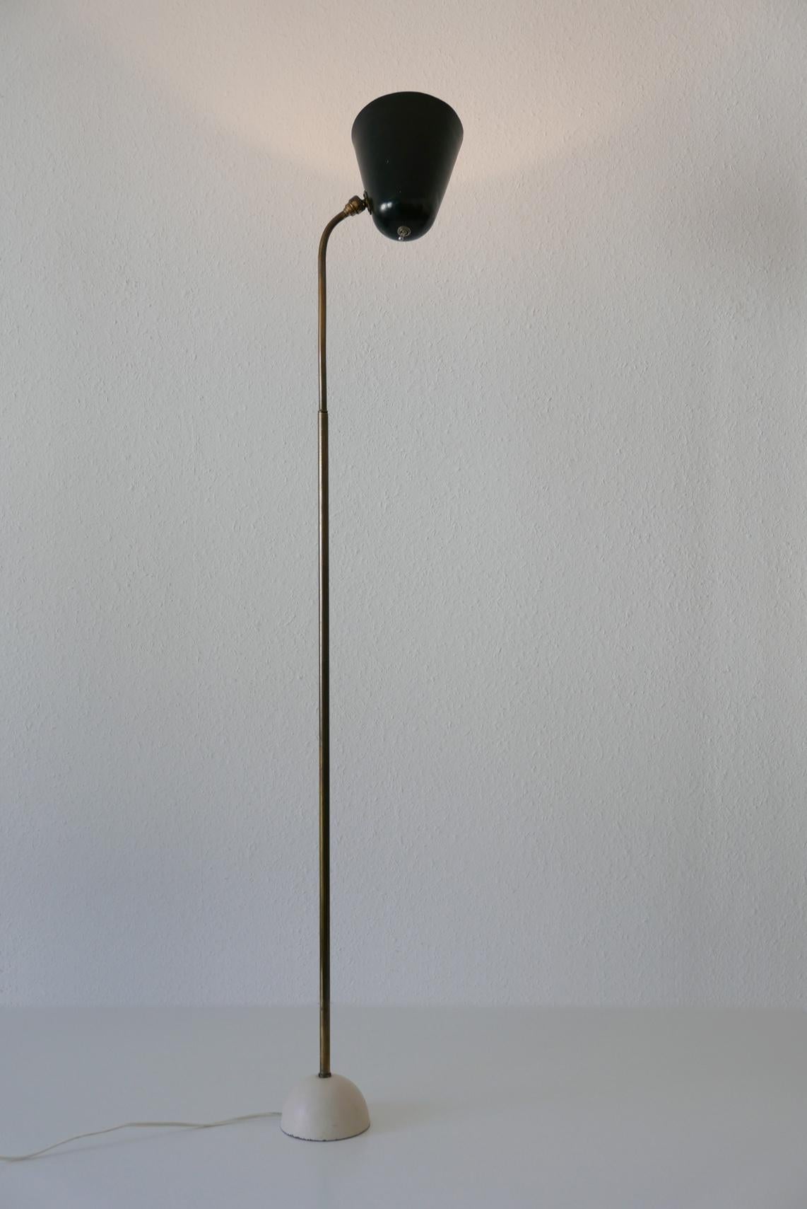 Extremely rare and elegant Mid-Century Modern floor lamp. Designed and manufactured in 1950s, Germany. 
Due to joint ball, lamp shade can be directed in every position. Adjustable height.

Executed in brass, aluminium and cast metal. The lamp needs