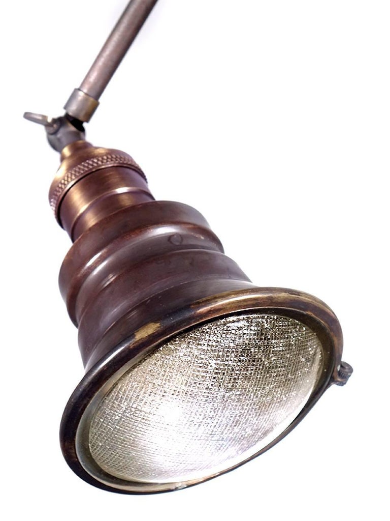Pictured are mini spot pendants. They come in a dark brass finish. The interiors are silvered and an brass ring holds a textured glass lens. It’s 16 in. long including the brass socket and has a 3.75 in. diameter. These lamps work well in numbers,