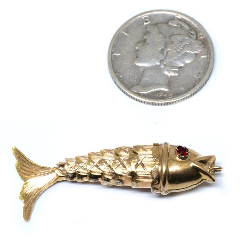 This meticulously crafted fish is finely articulated with small ruby eyes.

Charm details:
Metal: 18 Karat Yellow Gold
Weight: 2 grams

Payment & Refund Details:
*More Pictures Available on Request*

* Layaway *
We will be more than happy to provide