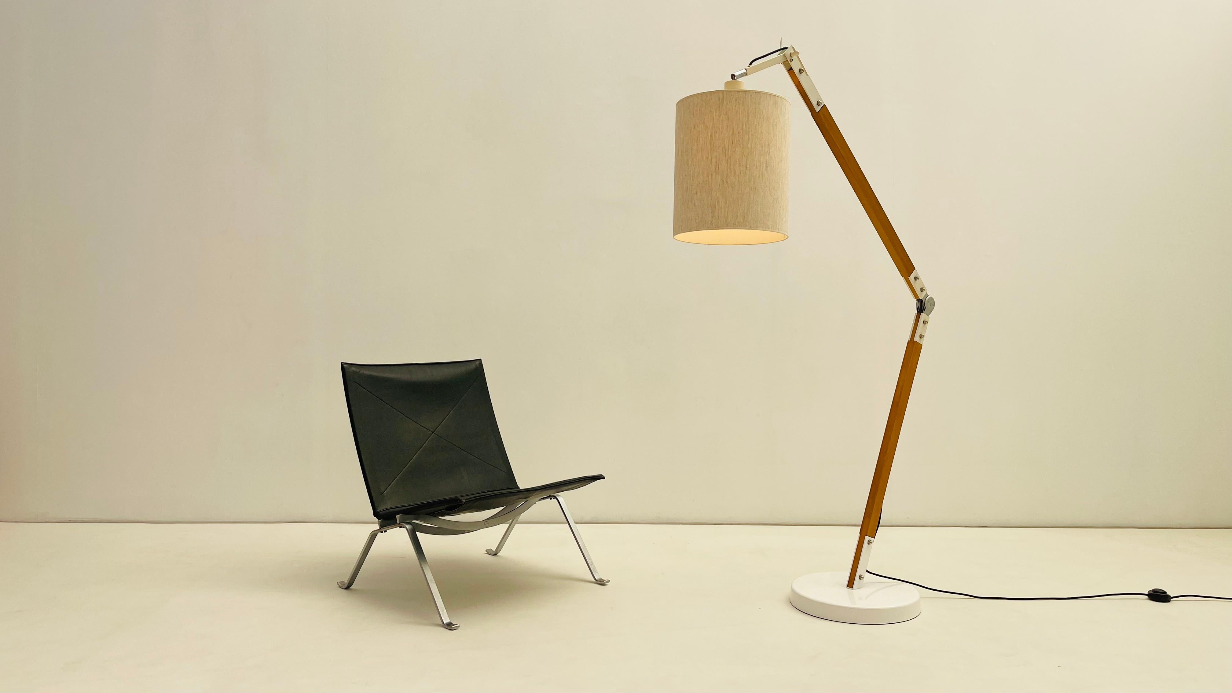 Articulated Floorlamp in fruitwood and white metal thermo-painted. 

Can fit for a reading corner or over the coffee table in the living room. this lampshade gives your room a warm and cosy light. Its clever structure can be adapt to any ceiling