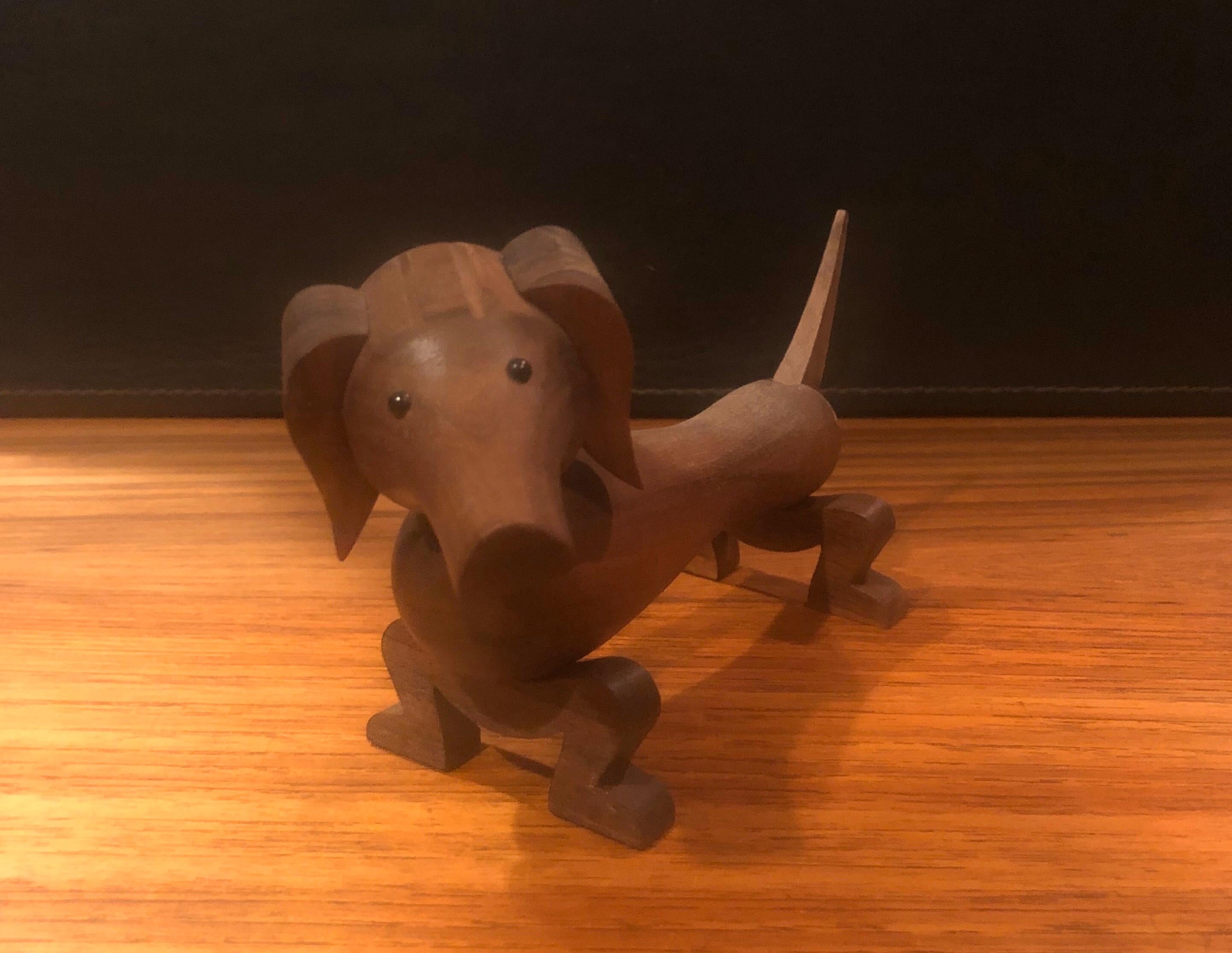 Articulated toy dachshund / dog by Kay Bojesen, circa 1990s.

Kay Bojesen's dachshund, born in 1934, is a world-famous classic for children and adults alike. 

The dog is made of gorgeous solid walnut and his limbs, head and tail articulate
